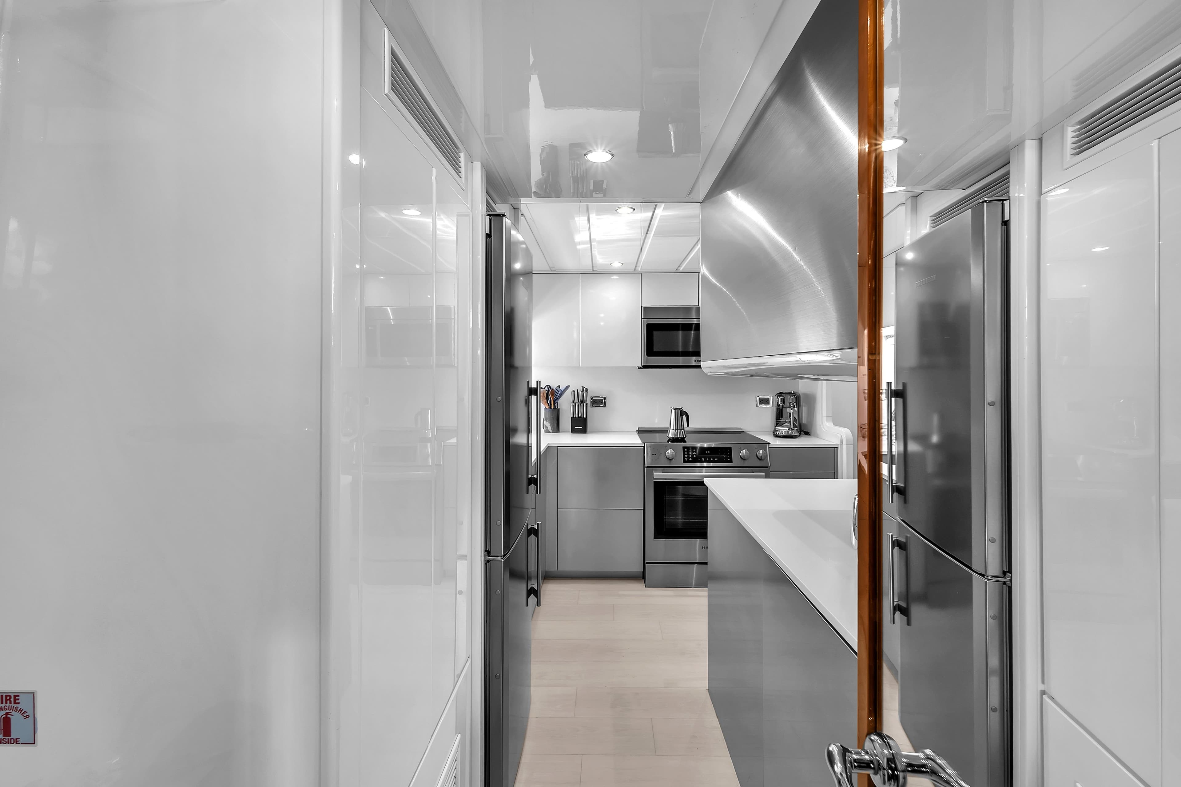 Modern kitchen interior on 2002 Ferretti Yachts Custom Line 94, featuring sleek appliances and cabinetry.