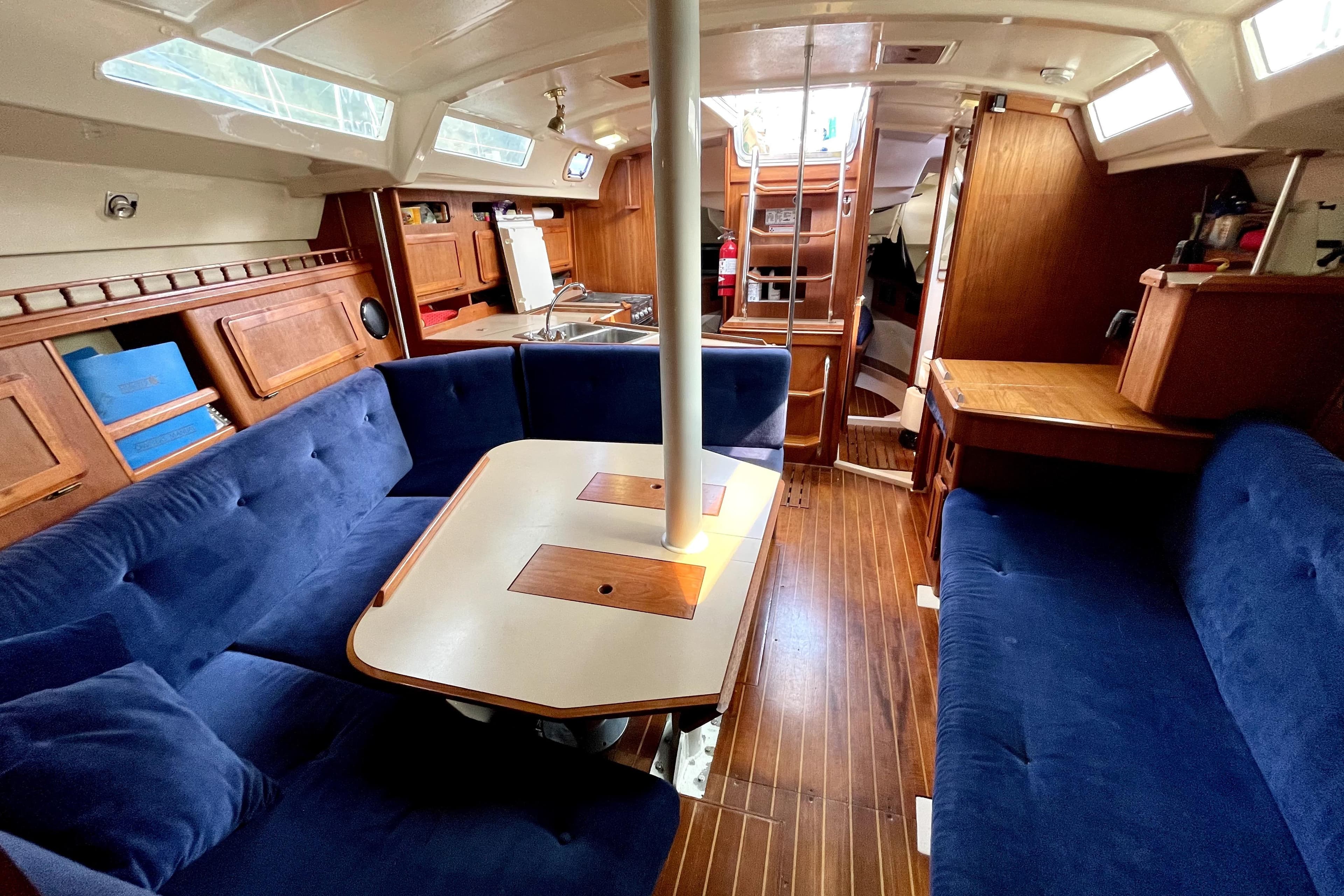 Interior of 1989 Hunter 40 Legend sailboat with blue seating and wooden accents.