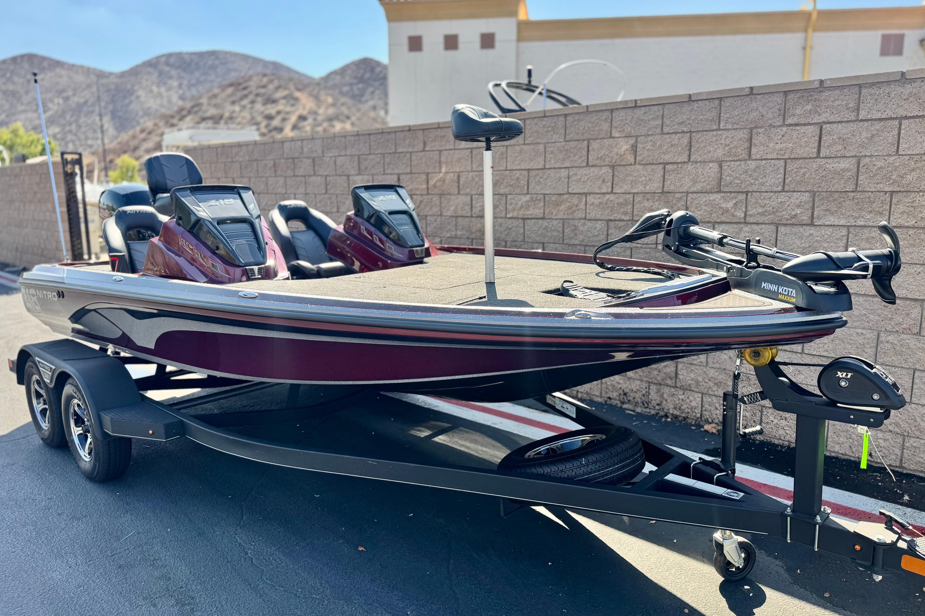 2023 Nitro Z18 boat on trailer, parked outdoors, featuring dual consoles and trolling motor.