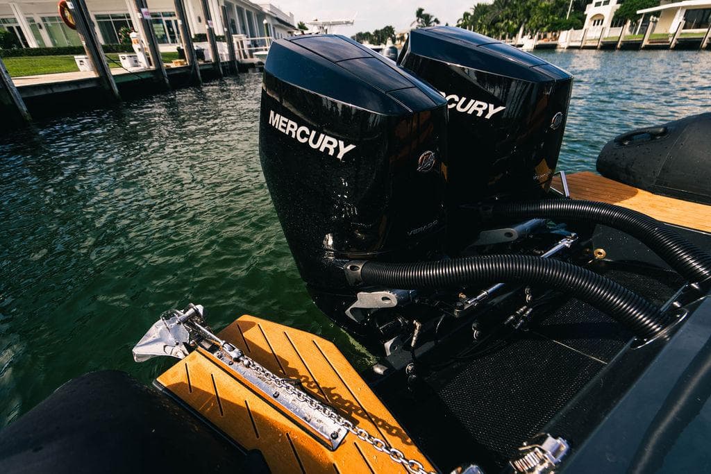Twin Mercury outboard engines on a 2024 Onda Magna boat docked at a marina.