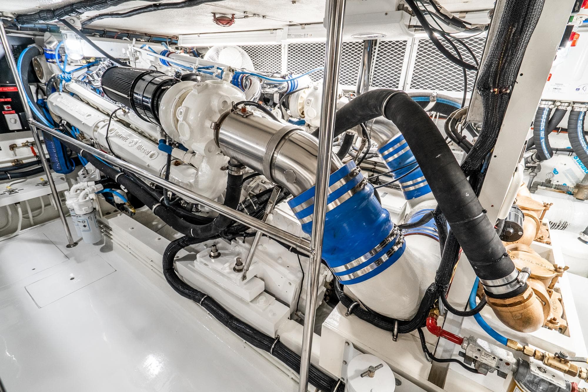 Engine room of 1990 Hatteras 58 Sportfish, showcasing powerful marine engine components.