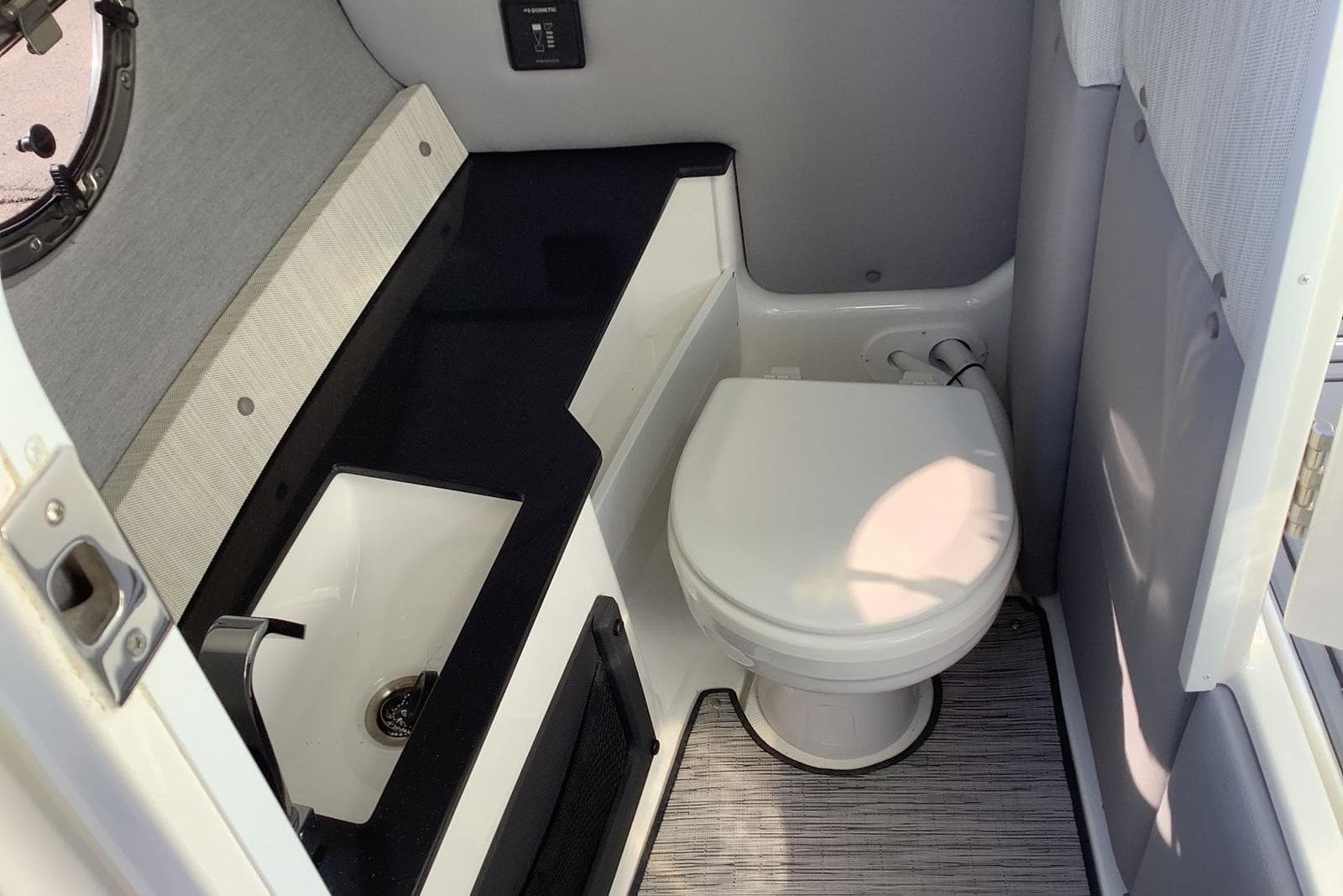 2022 Cobalt R6 Surf boat interior bathroom with toilet and sink.