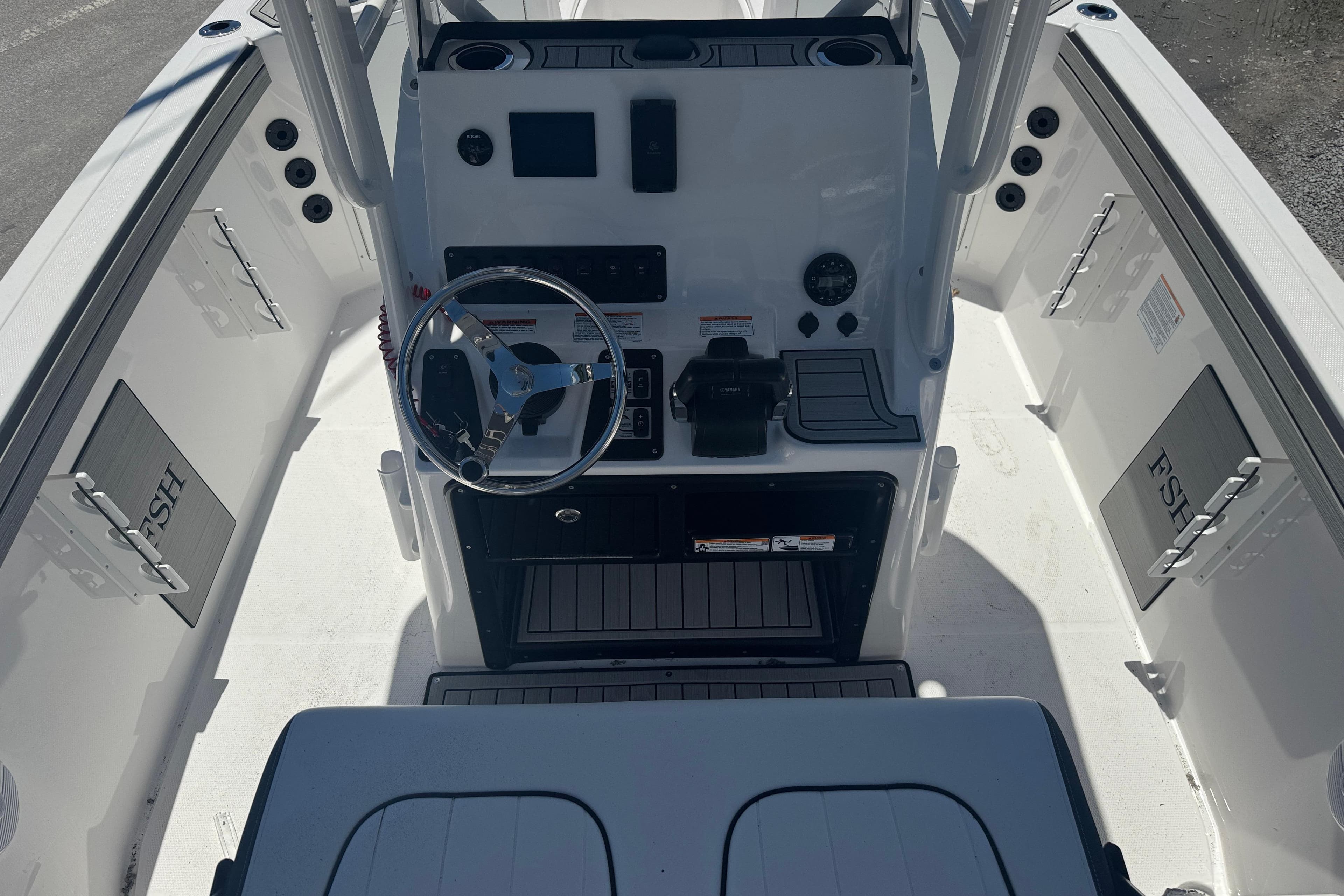 2026 Yamaha Boats 220 FSH Sport dashboard and steering wheel, featuring modern controls.