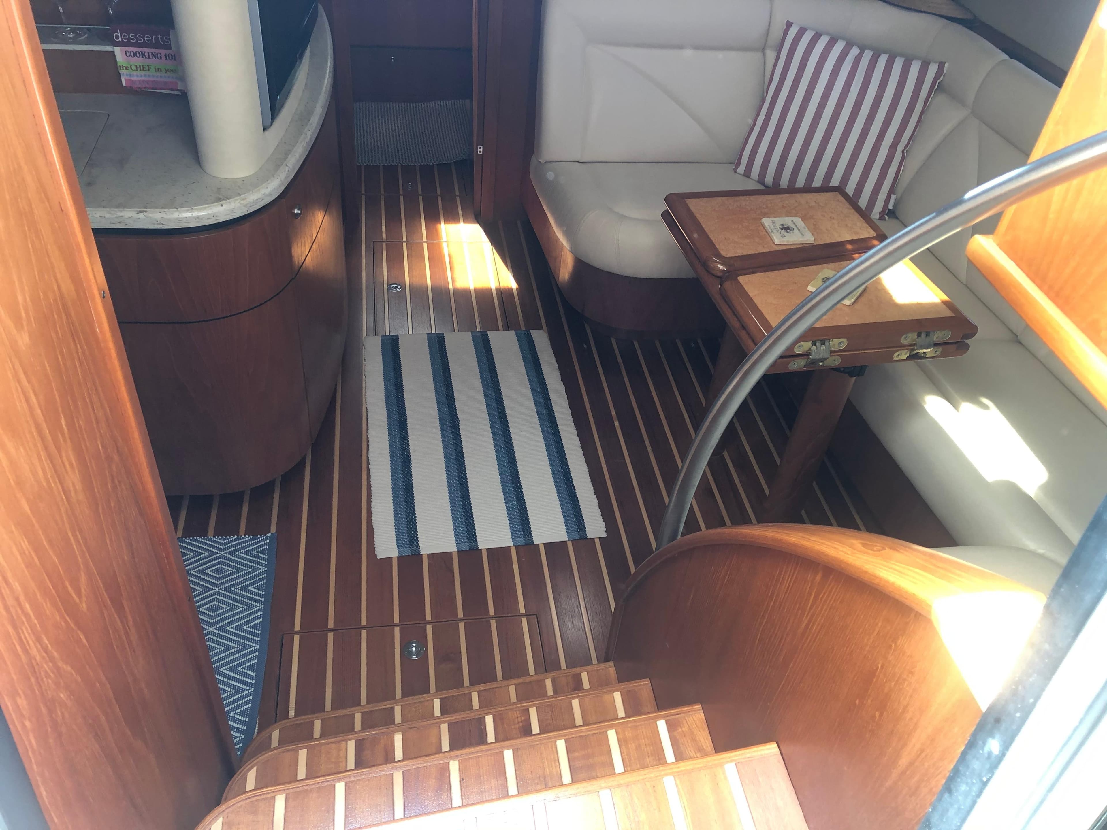 Interior of 2009 Tiara Yachts 4300 Sovran with wooden flooring and seating area.