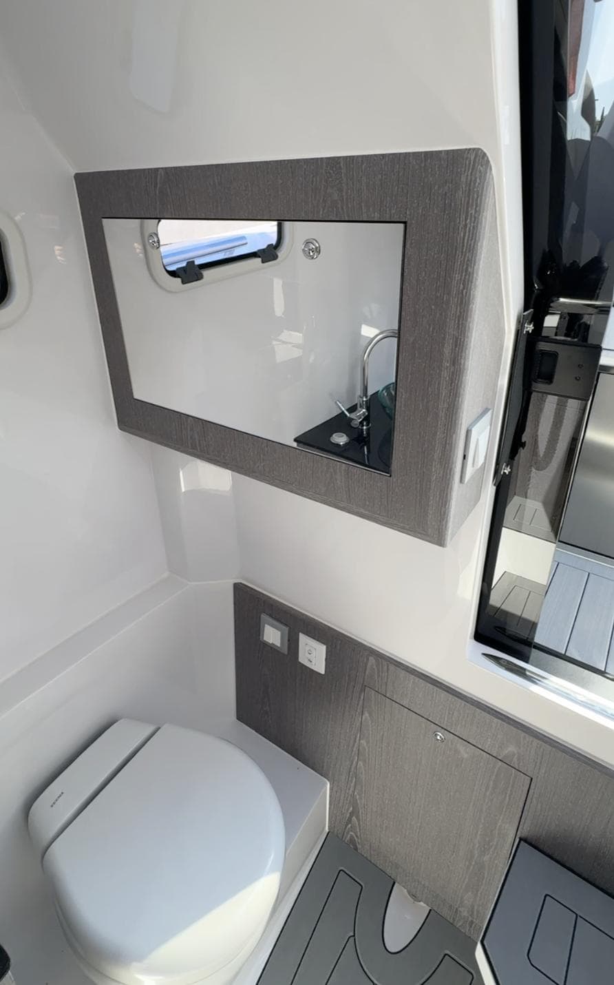 Modern bathroom interior in 2024 Pirelli 30 boat, featuring sleek design and compact amenities.
