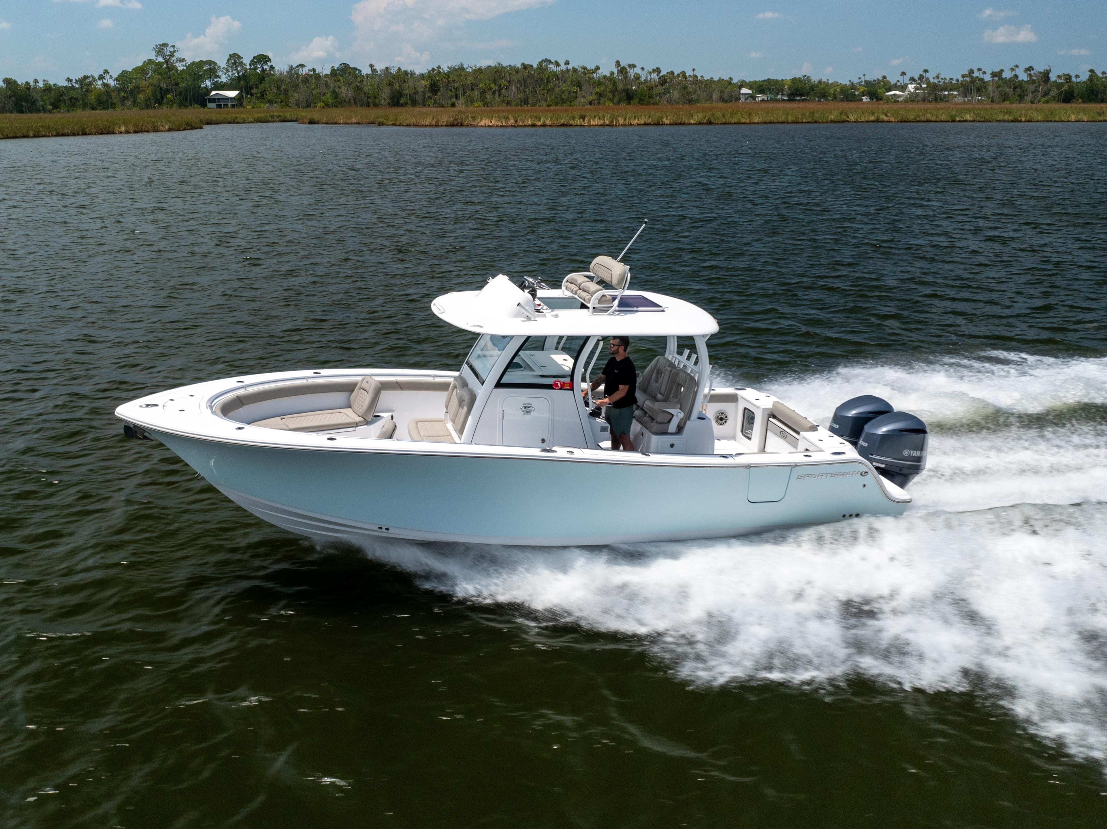 2021 Sportsman Open 302 Center Console boat cruising on a lake.