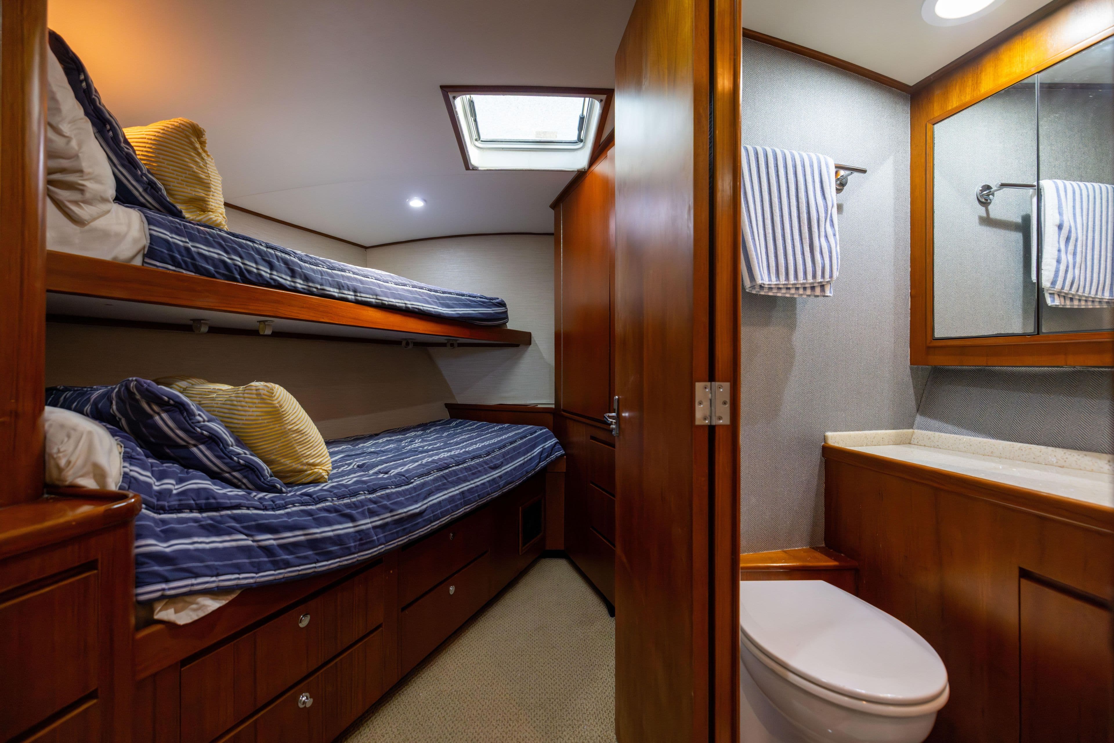Luxurious 1996 Jim Smith 60 Sportfish cabin with bunk beds and ensuite bathroom.