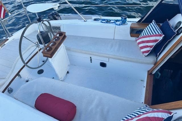 Cockpit of 1987 Catalina 30 Mk II sailboat with seating and nautical decor.