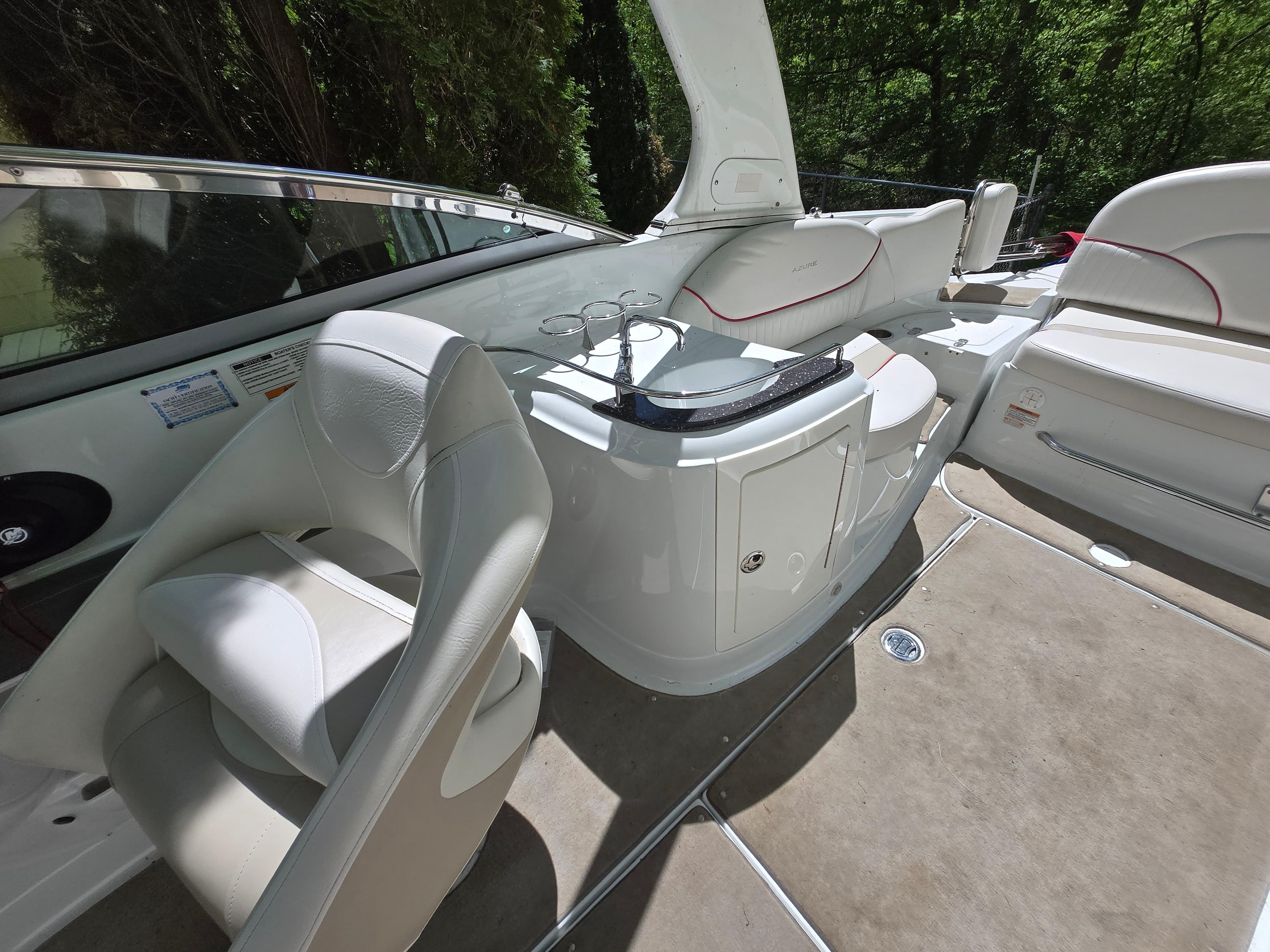 Luxurious interior of 2009 Azure AZ298 boat with white seating and sleek design.