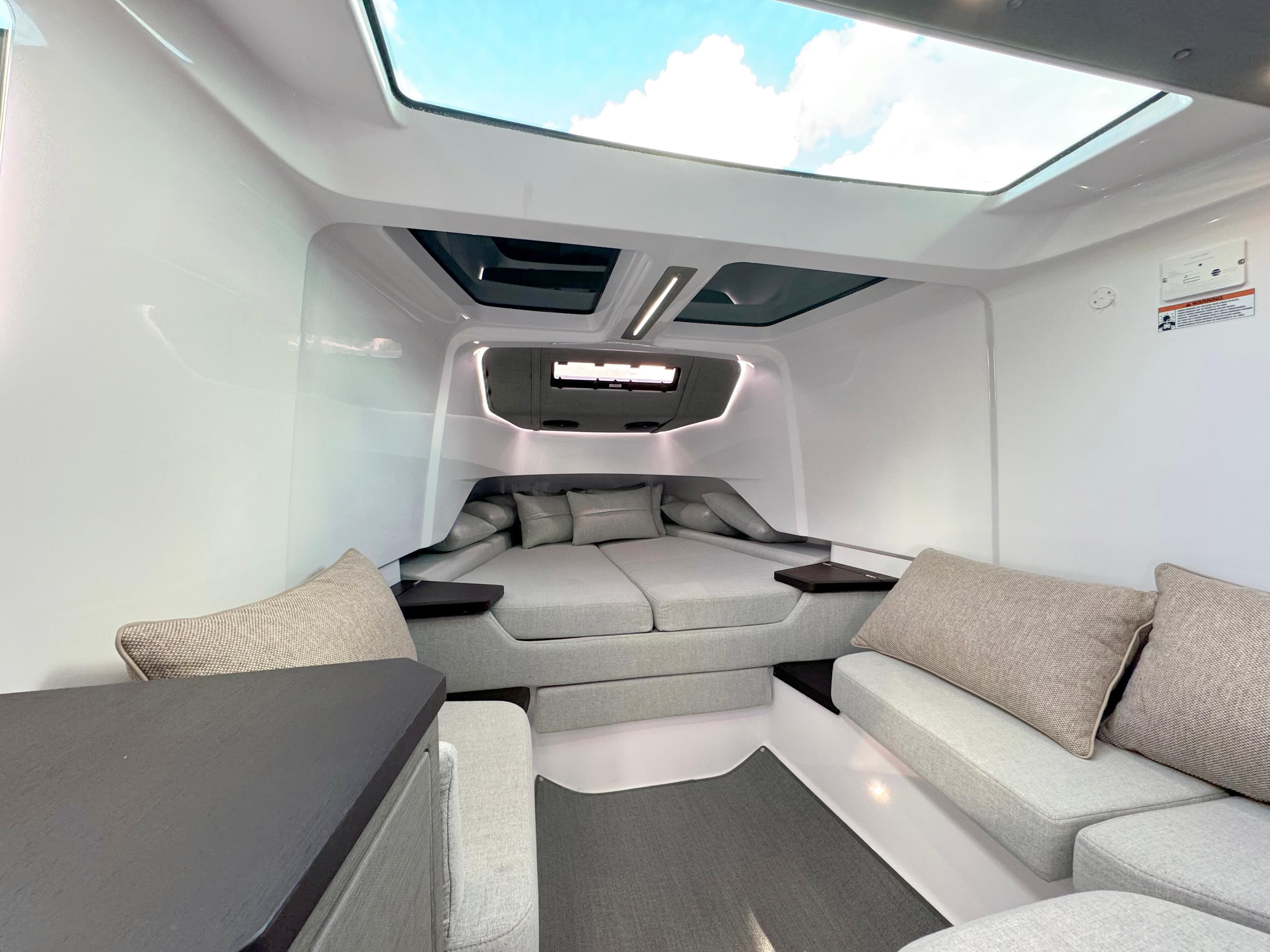 2024 Axopar 37XC CROSS CABIN interior with modern seating and skylight.