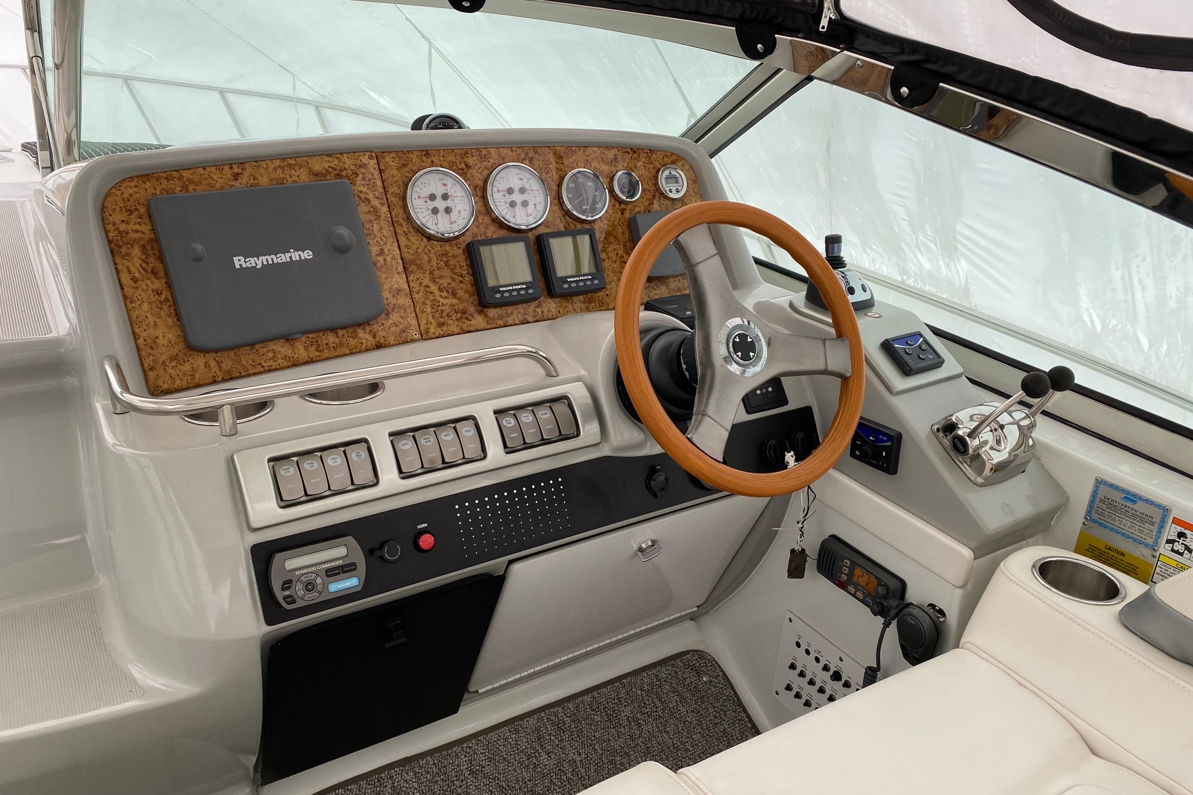 2007 Formula 40 Performance Cruiser helm with Raymarine navigation and wood-accented steering wheel.