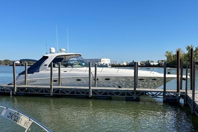2001 Sea Ray 460 Sundancer yacht docked on a sunny day.