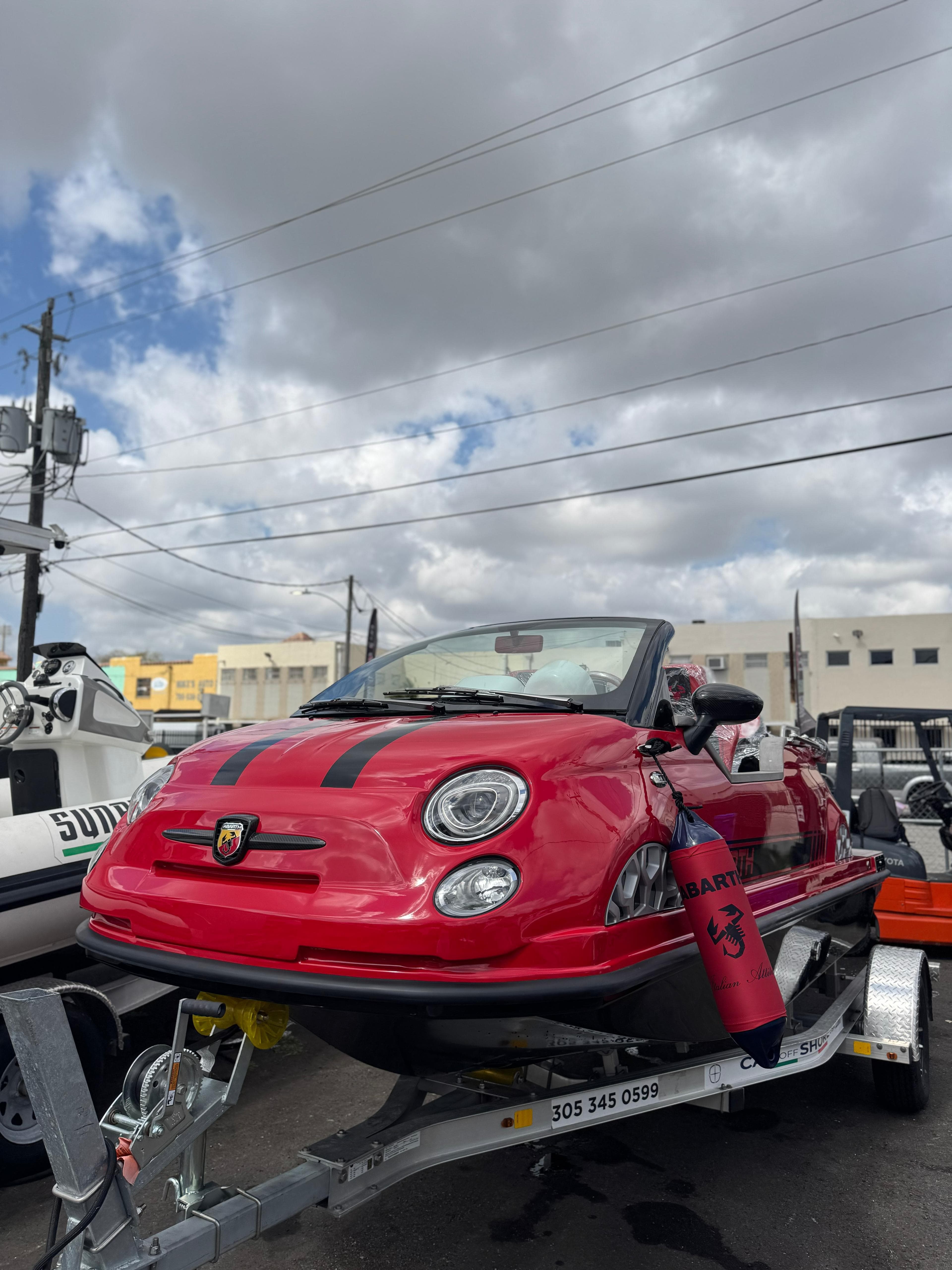 2025 Car Off-shore Fiat 500 Abarth boat on trailer under cloudy sky.