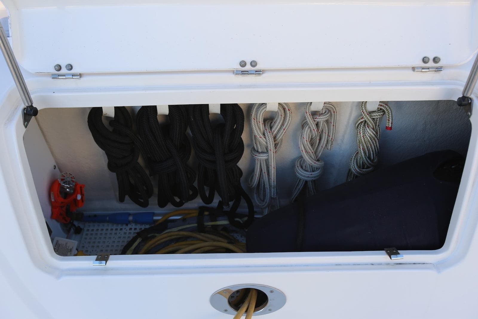 Storage compartment with ropes on a 2004 Sea Ray 420 Sedan Bridge boat.