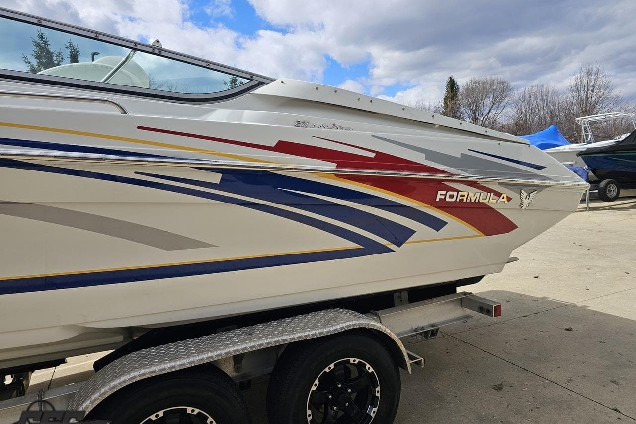 2008 Formula 271 FASTech boat on trailer, featuring colorful graphics and sleek design.