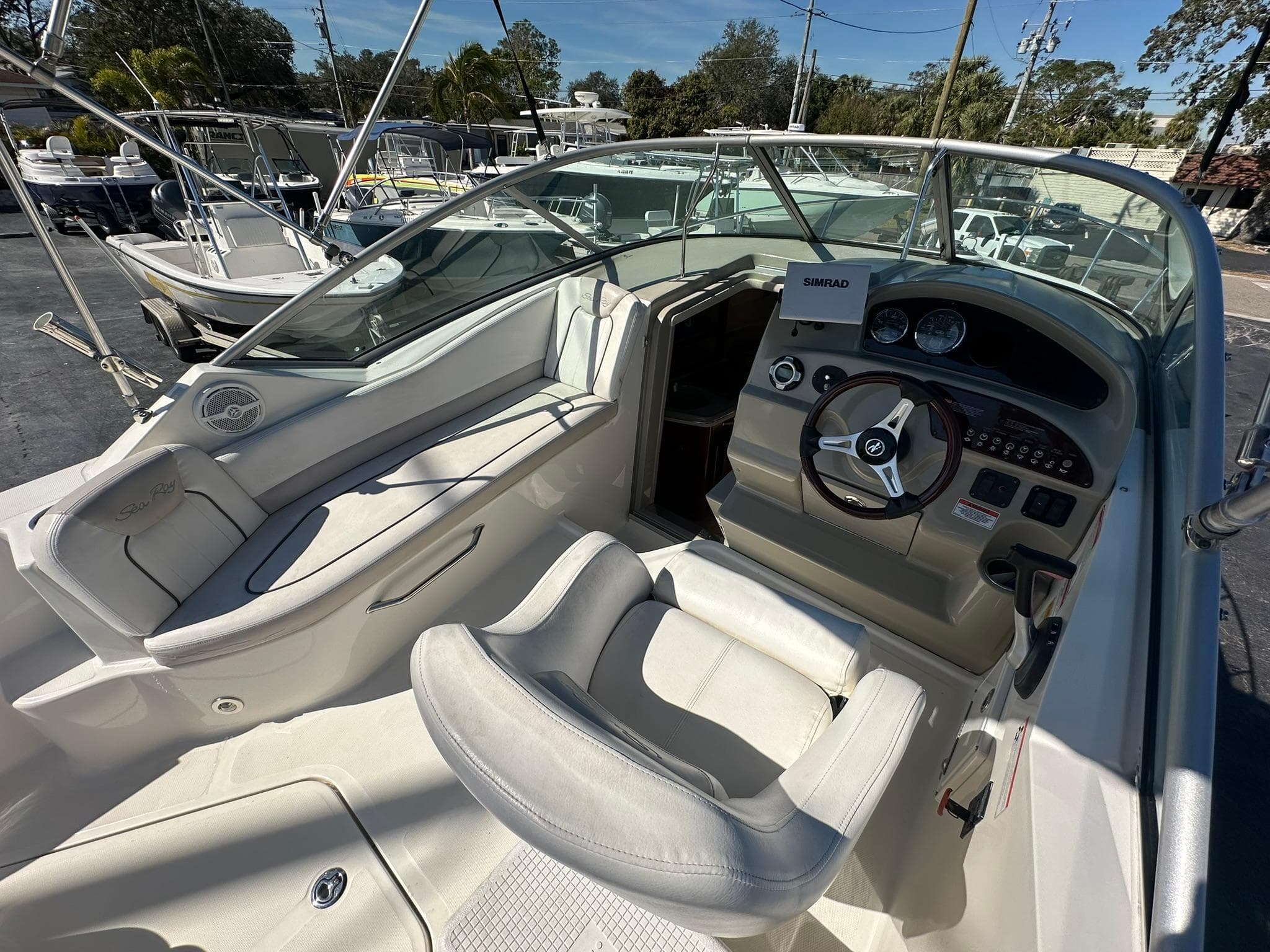 2010 Sea Ray 240 Sundancer boat interior with steering wheel and seating area.