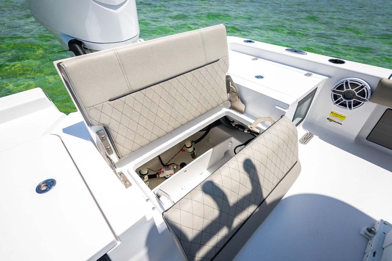 Manufacturer Provided Image: 2025 Sportsman Masters 247 Bay Boat with open storage compartment, beige seating, and ocean backdrop.