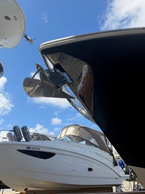 2016 Sailfish 275 DC boat in harbor, blue sky.
