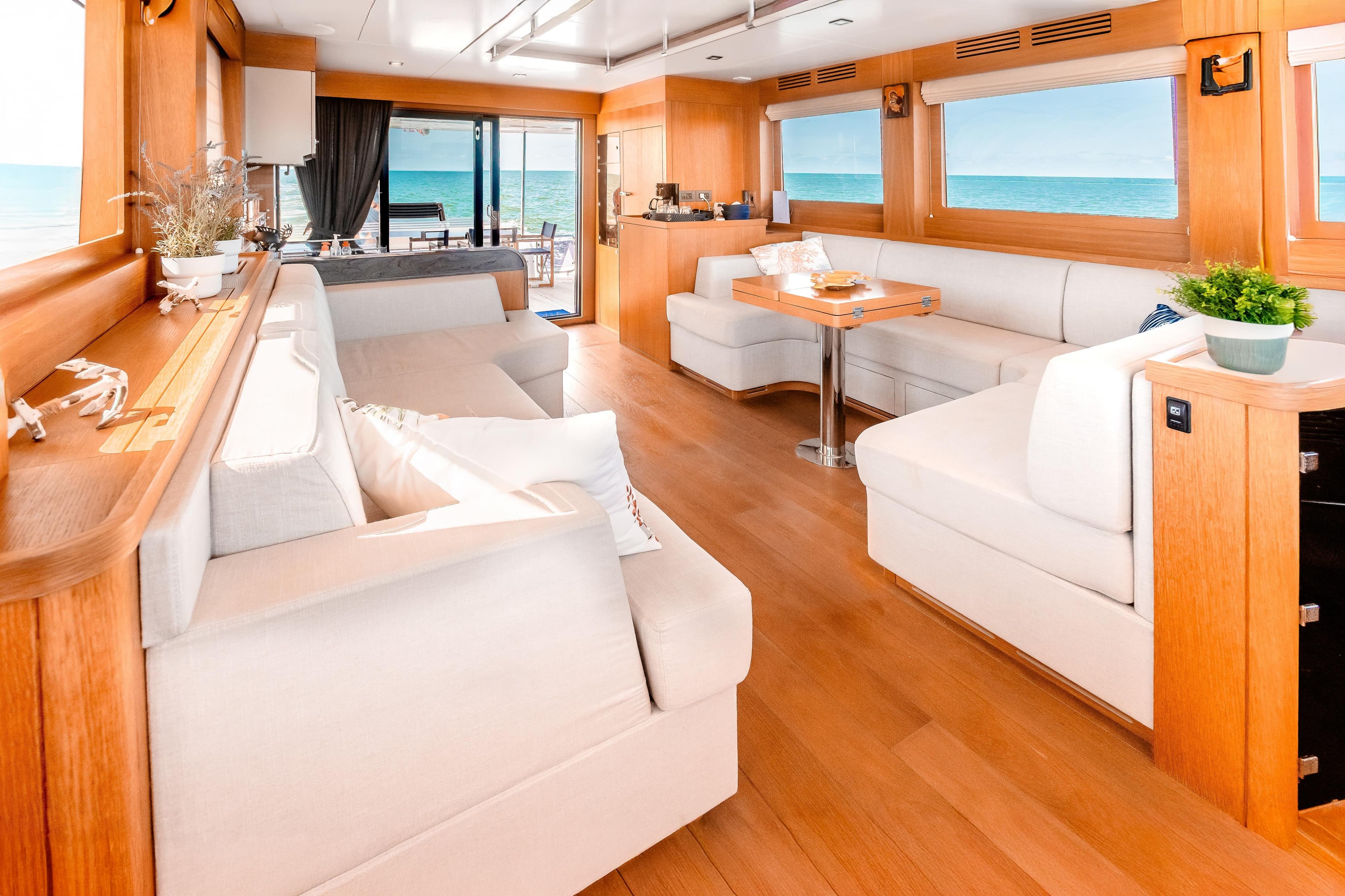 Luxurious interior of 2023 Sirena 58 yacht with elegant seating and ocean view.