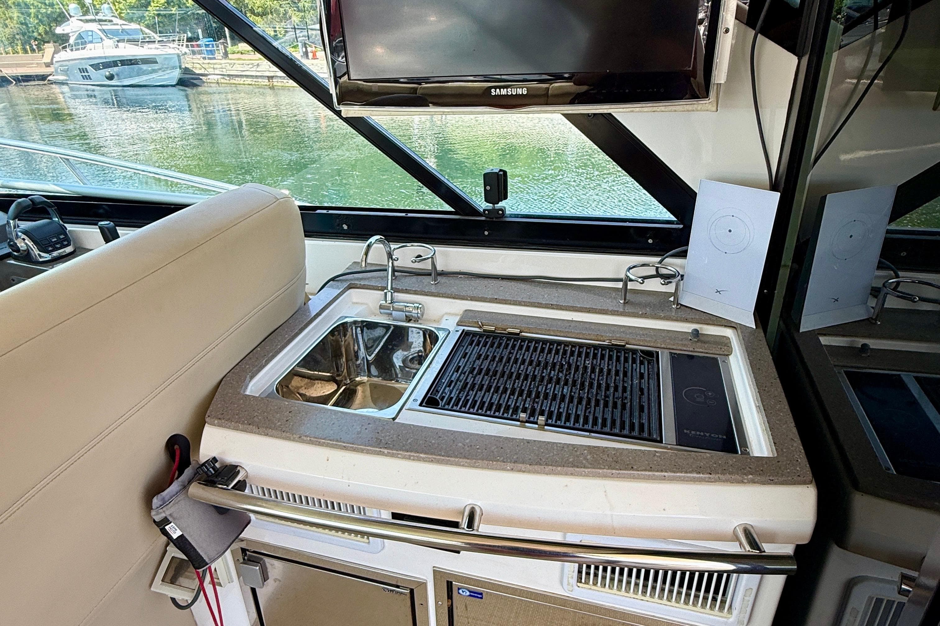 2012 Regal 42 Sport Coupe yacht interior with sink, grill, and TV.