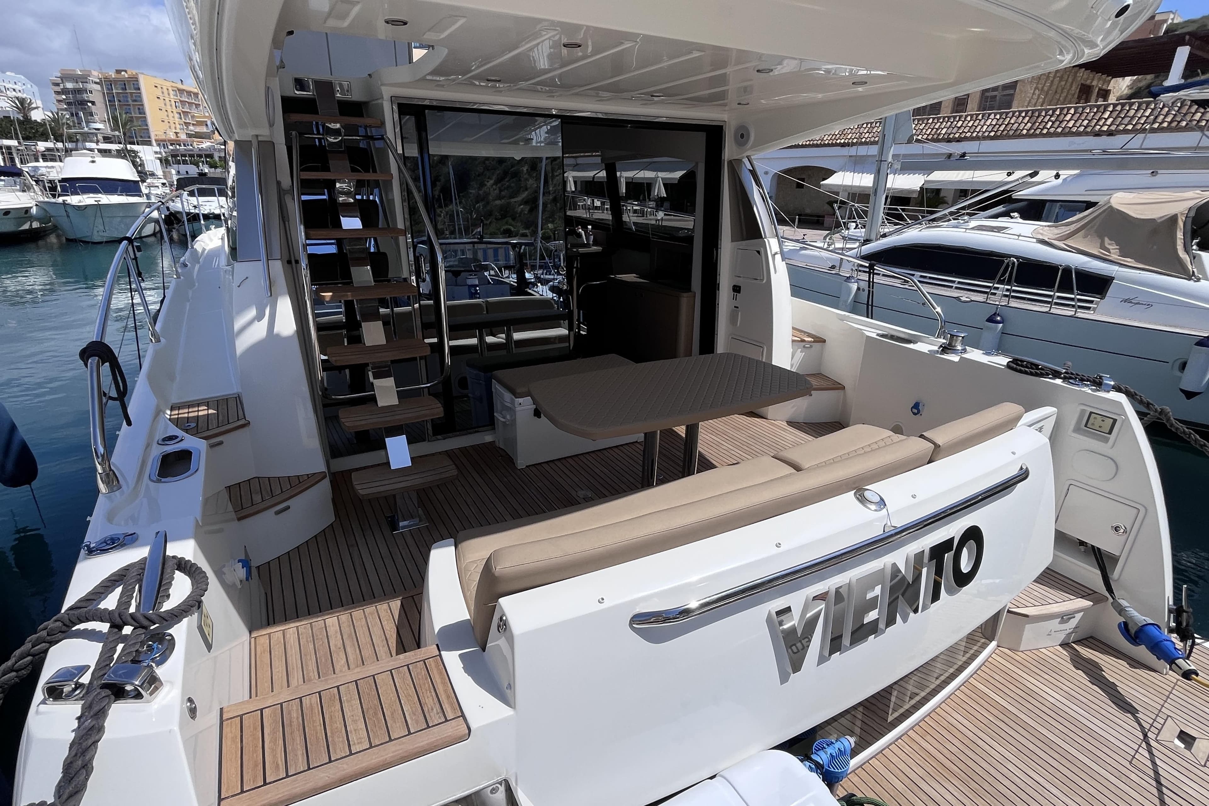 Luxury 2018 Prestige 500 yacht docked, featuring spacious deck and elegant seating area.