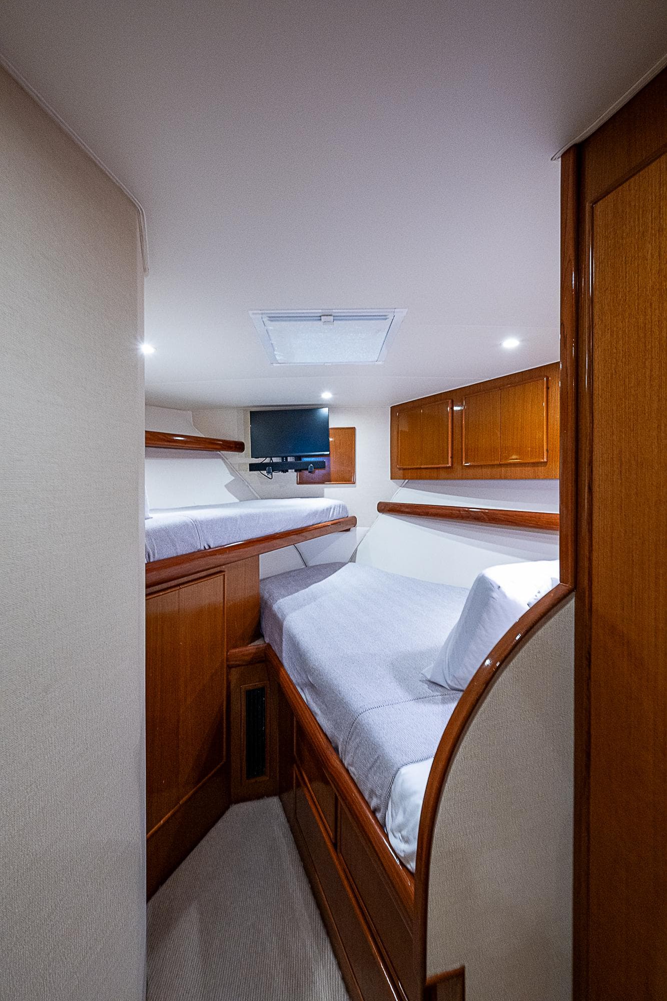 1999 Post 50 Convertible yacht interior with cozy twin beds and wooden cabinetry.
