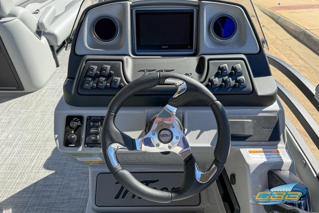 2026 JC 25 Neptoon LG boat dashboard with steering wheel and control panel.