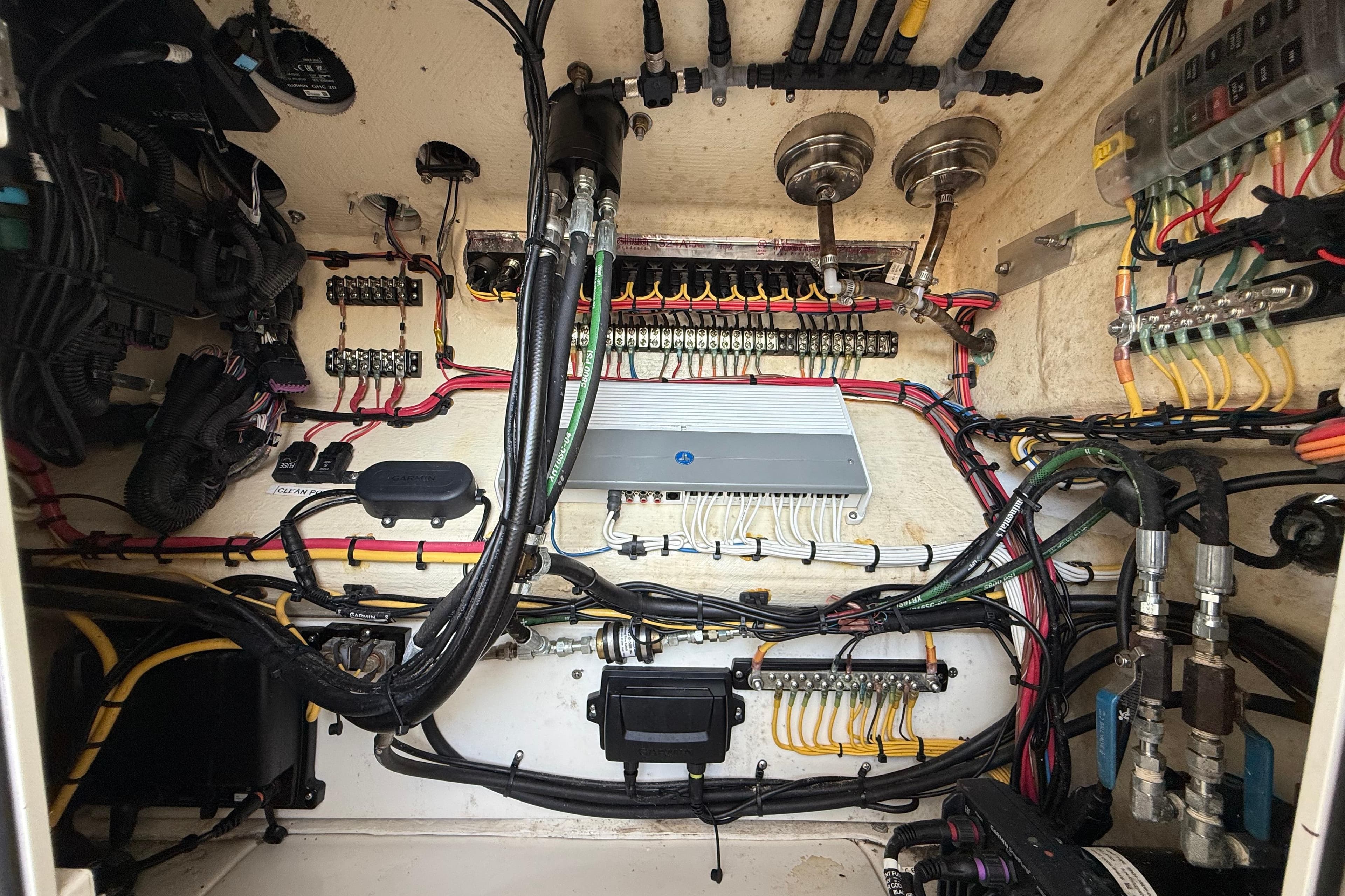 Electrical wiring system inside a 2020 SeaVee 290B boat, showcasing organized cables and components.