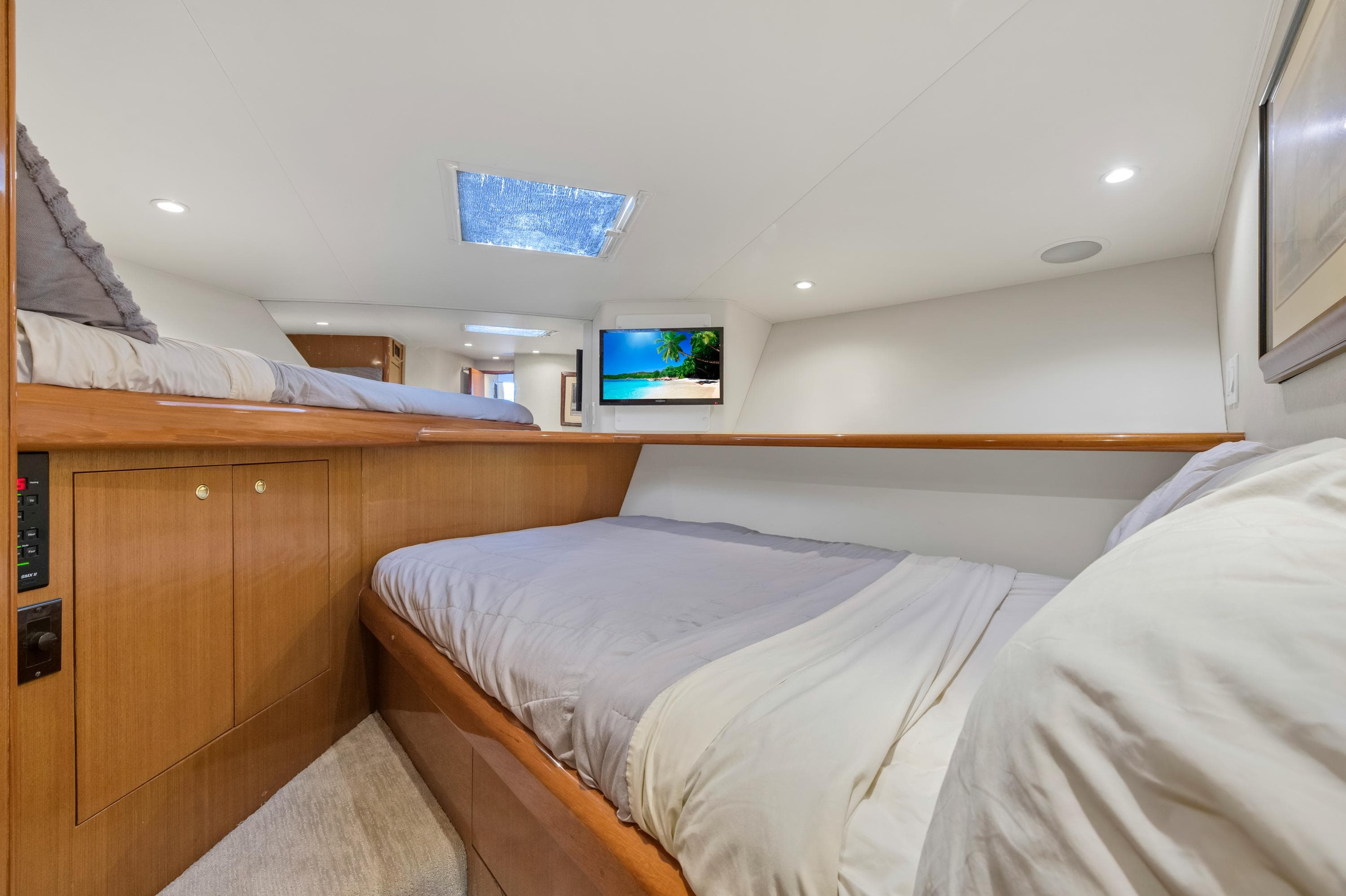 2001 Viking 55 Convertible yacht cabin with twin beds and TV.
