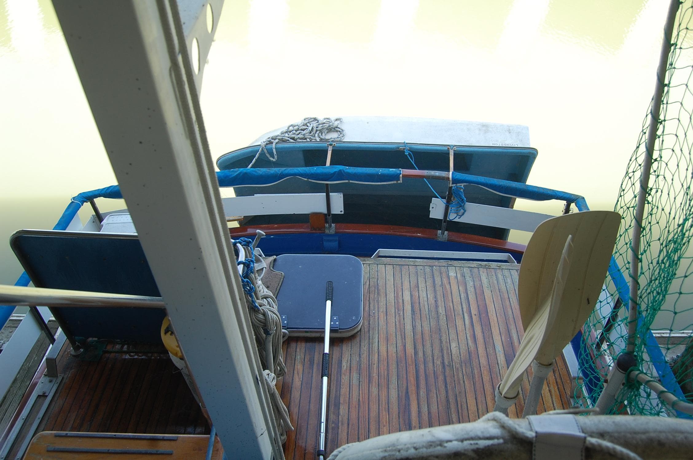 1983 Island Gypsy 36 Quad Cabin boat deck with wooden flooring and seating.