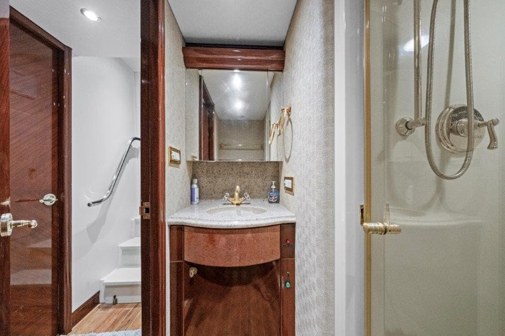 Luxurious bathroom on a 2006 Cheoy Lee Motor Yacht with elegant wood finishes and modern fixtures.