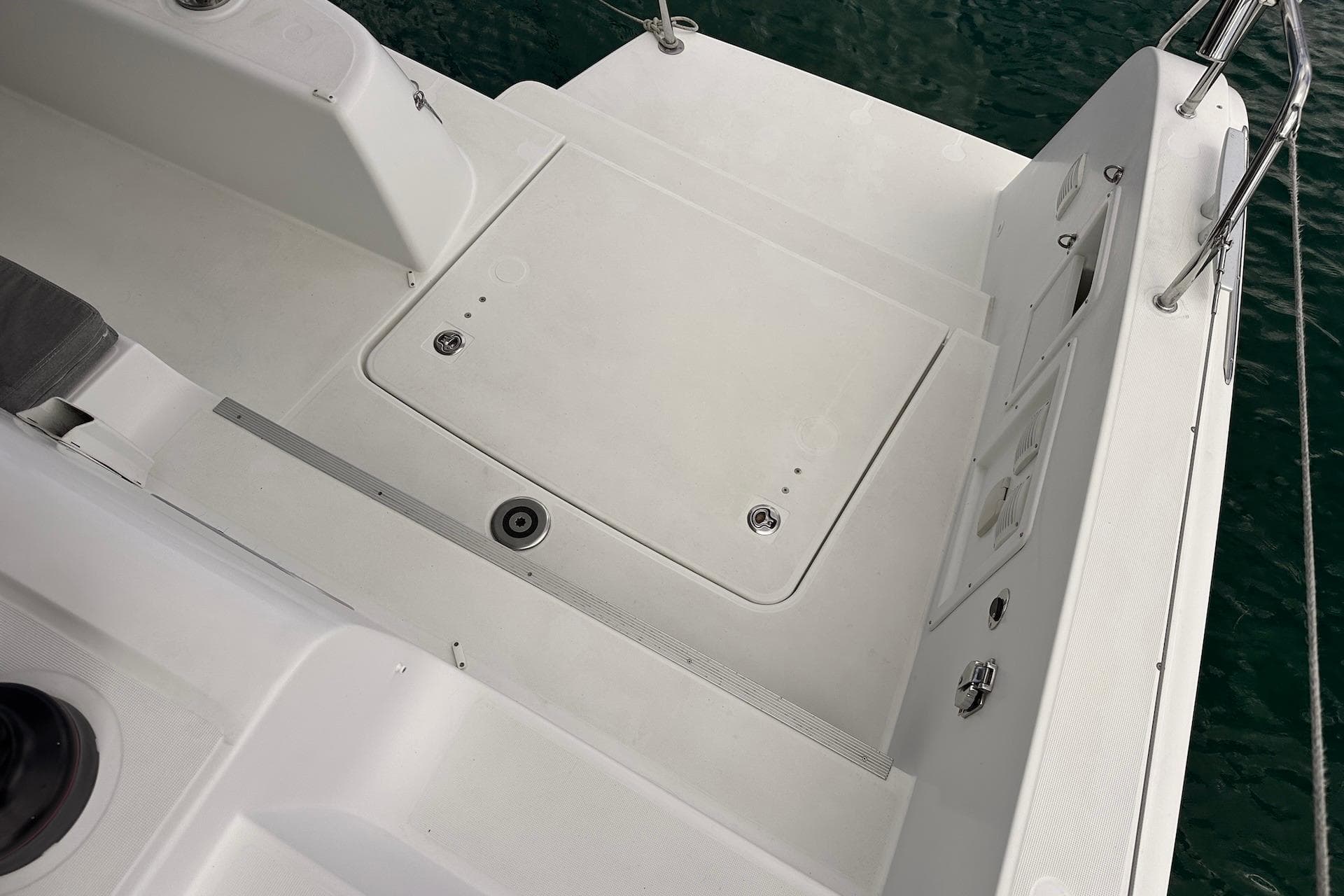 Deck of 2016 Lagoon 42 catamaran with clean, white surface and water view.
