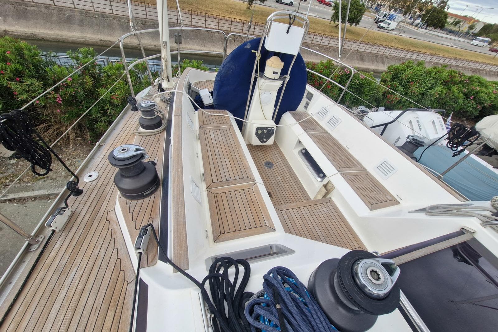 Deck view of a 2002 Nautor Swan 44 sailboat with teak flooring and winches.