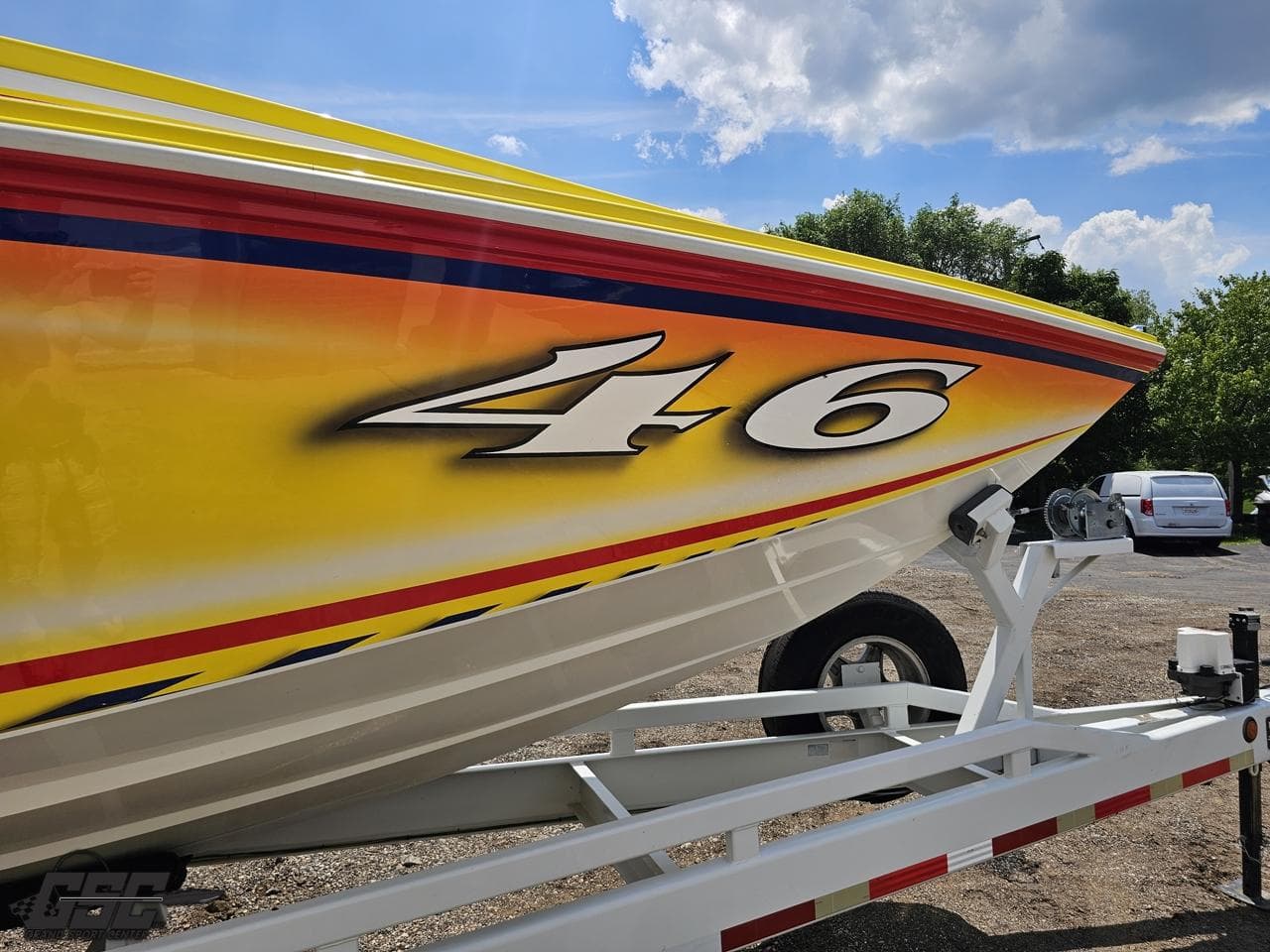 Yellow and red Sonic USA 45SS boat on trailer, sunny day, 2004 model.