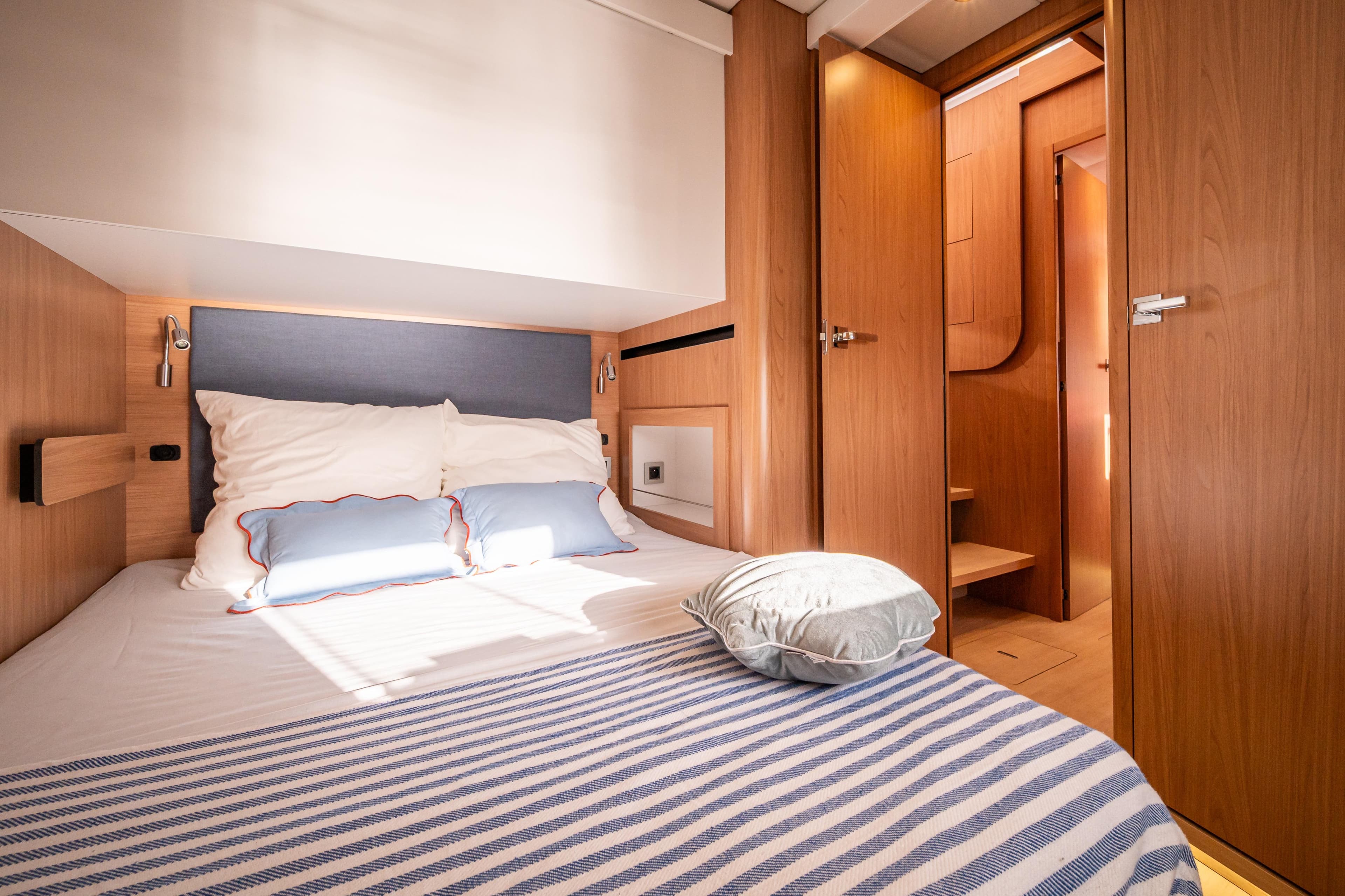 Luxurious cabin interior of 2026 Bali 5.2 yacht with cozy bedding and wooden finishes.
