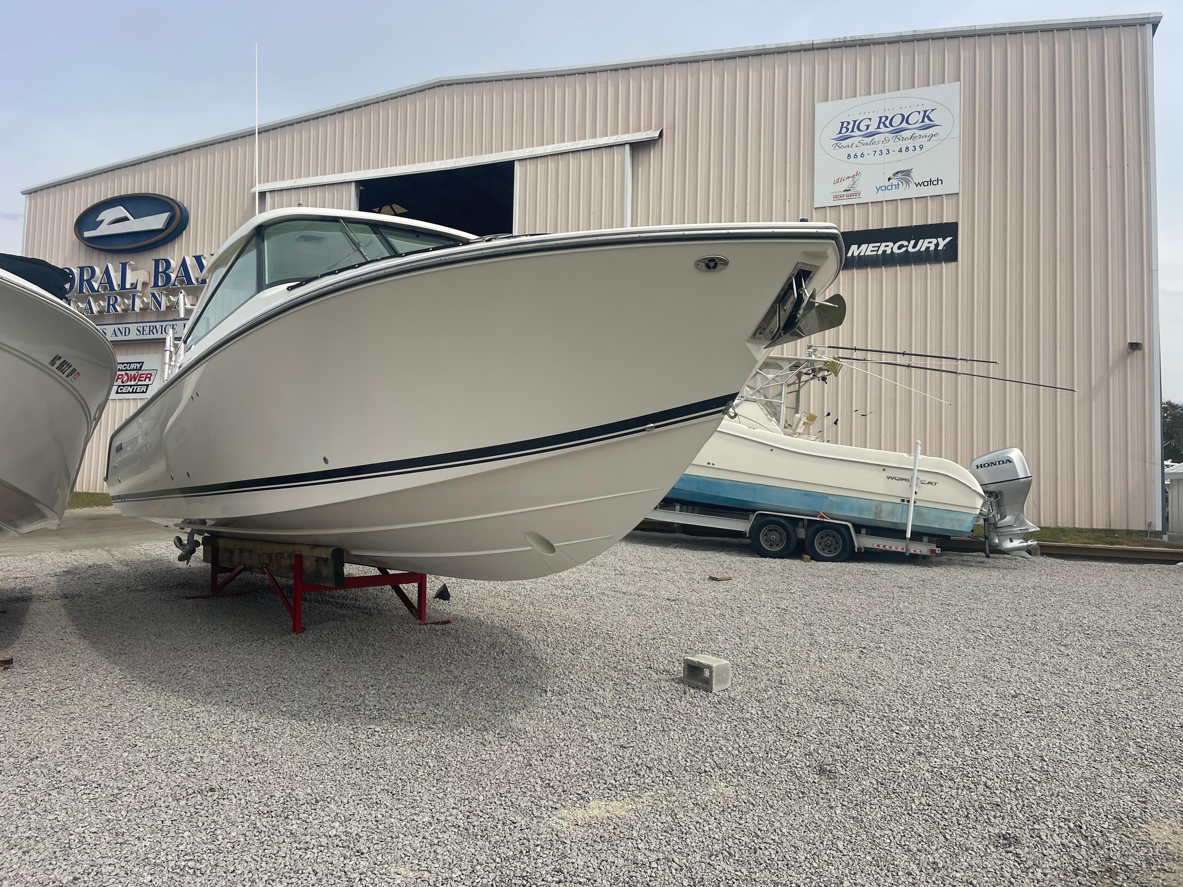 2016 Pursuit DC 325 Dual Console boat on gravel lot.