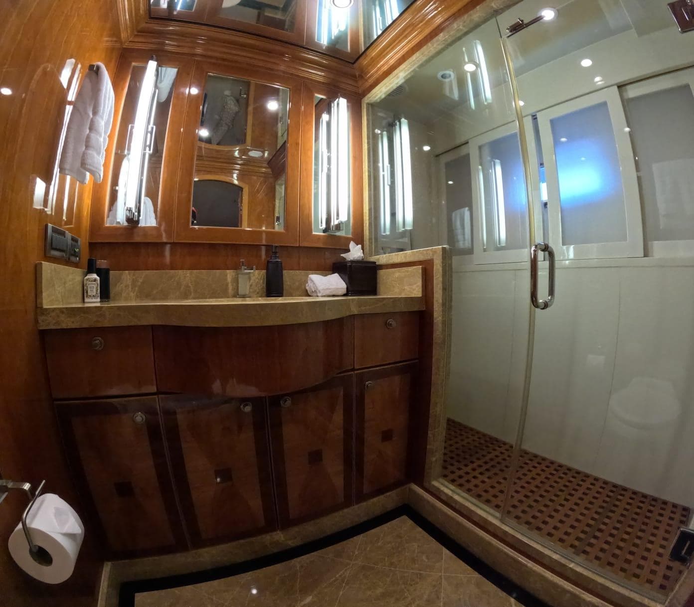 Luxurious bathroom on 2007 Hargrave 93' yacht with glass shower and elegant wood finishes.
