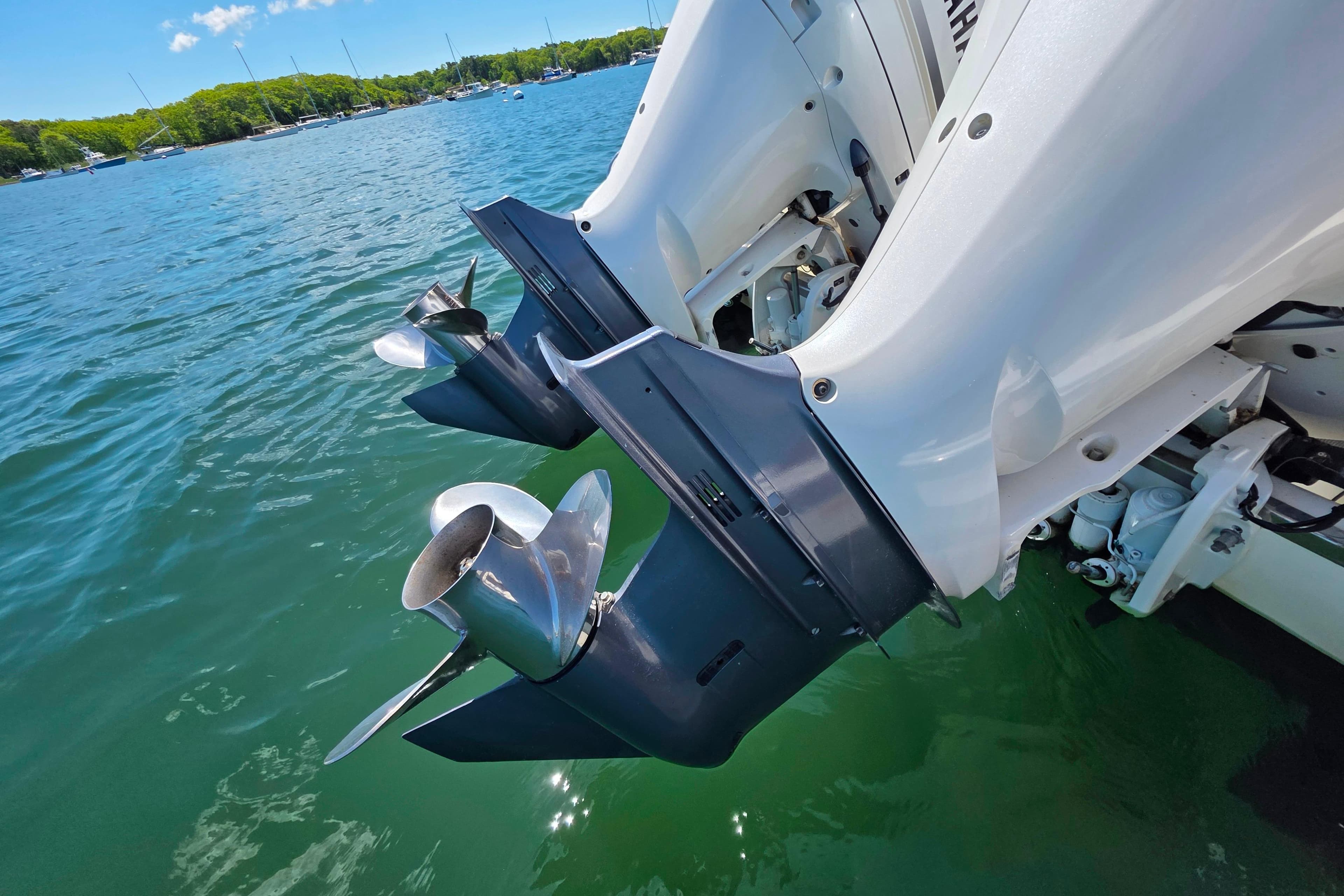 2020 Pursuit OS 325 Offshore boat engines in clear blue water.