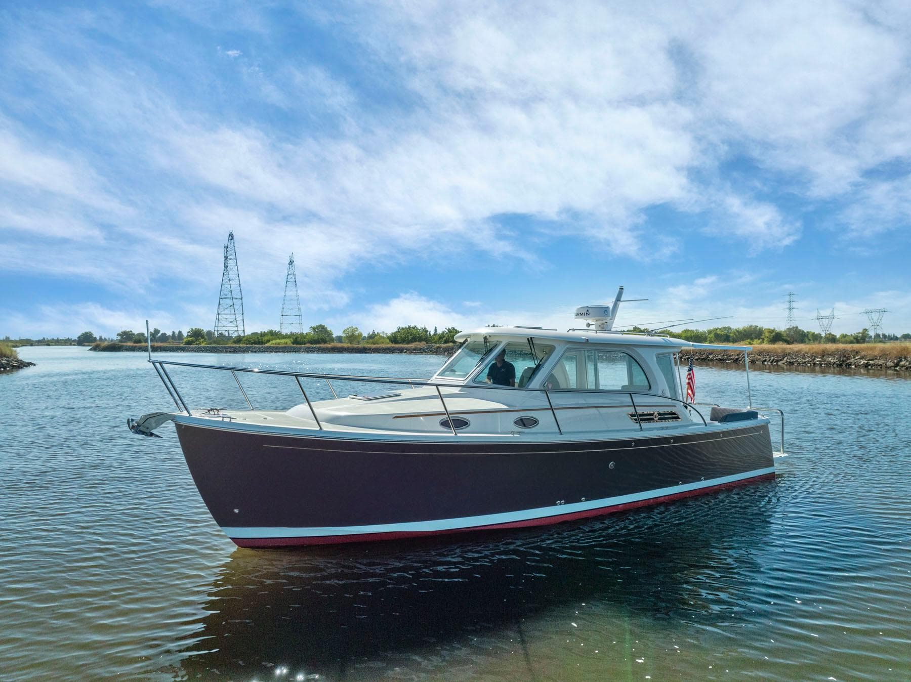 2018 Back Cove 32 boat on calm water under a clear blue sky.