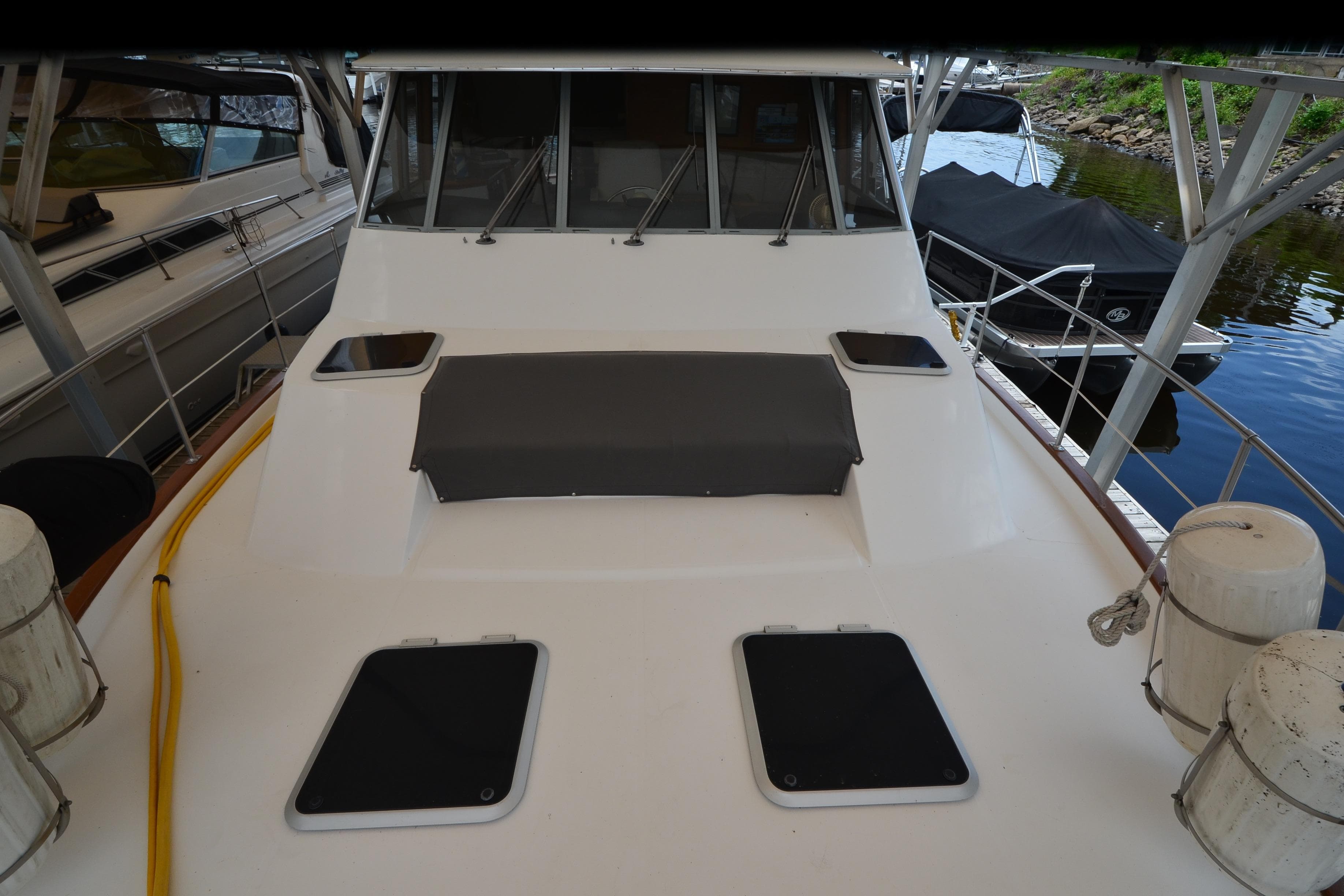 1989 Bayliner 4518 Motoryacht docked, showcasing spacious deck and sleek design.