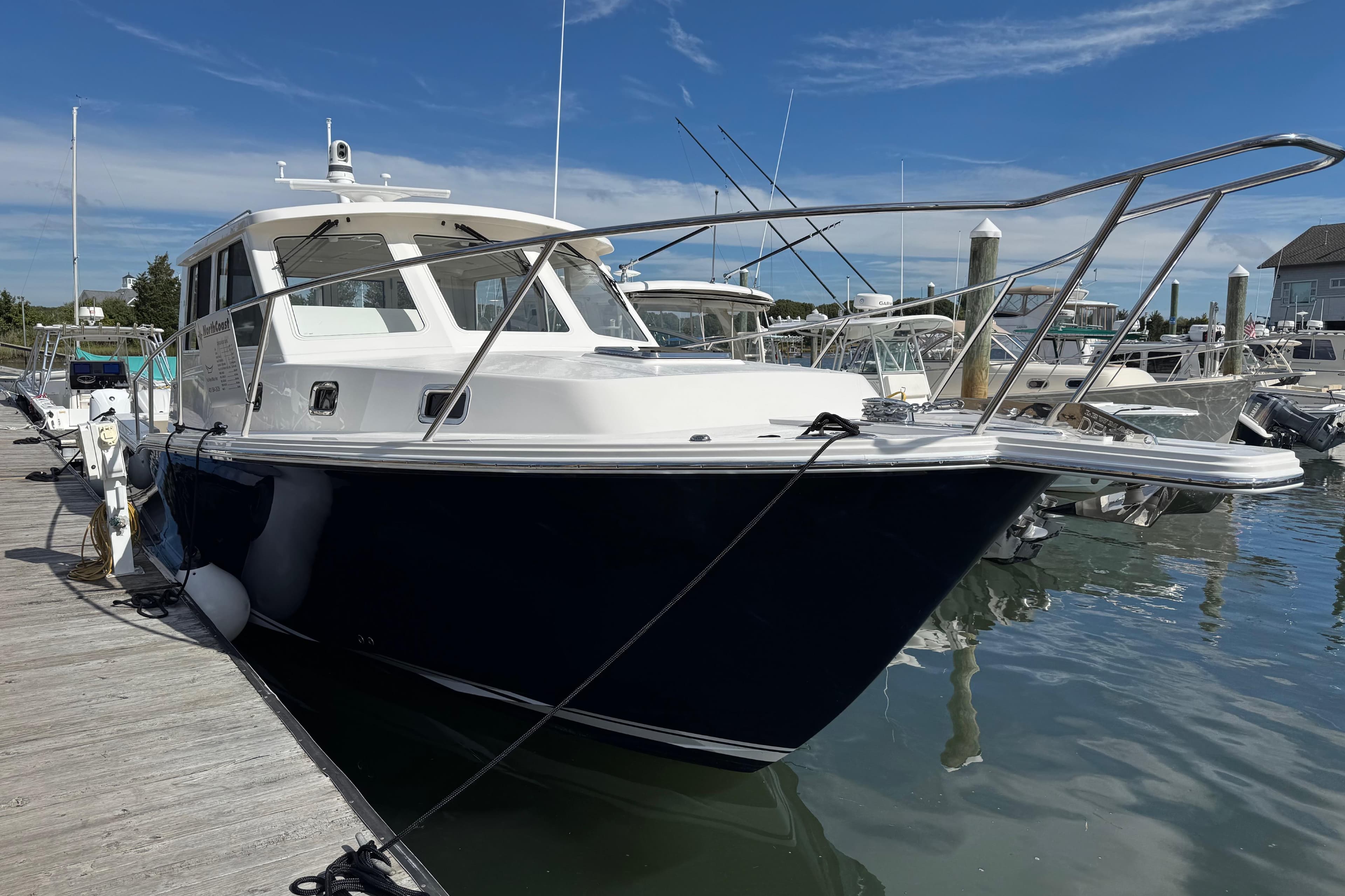 2026 NorthCoast 415 HT boat docked at marina under clear blue sky.