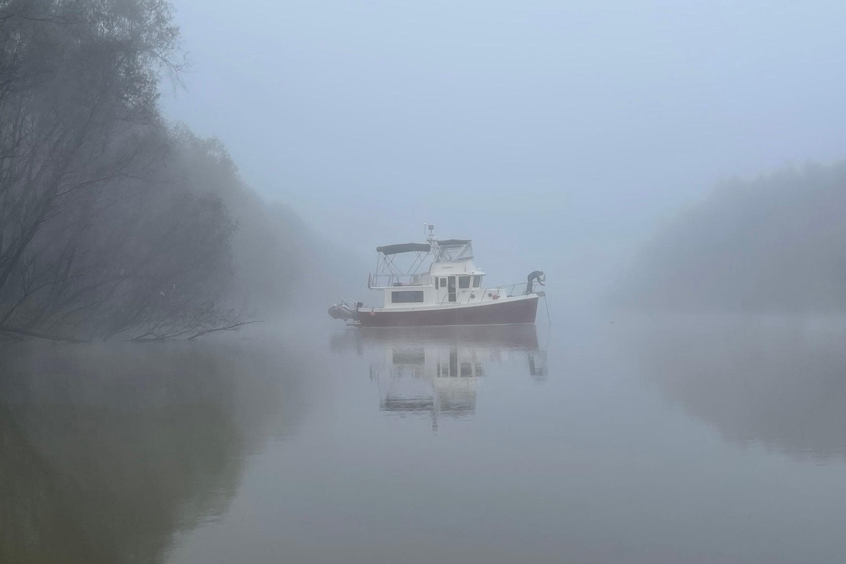 Foggy river scene with 2012 American Tug 365 Flybridge boat.