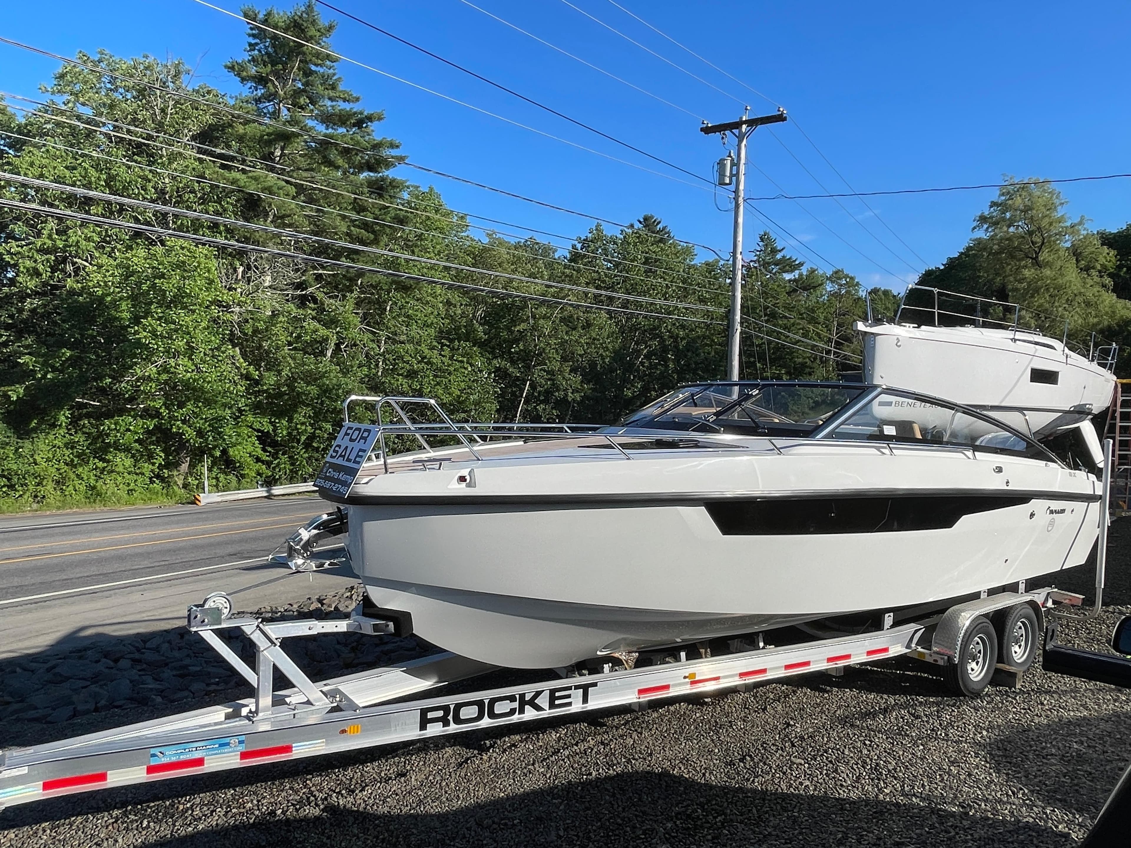 2023 Yamarin 88 DC boat on trailer, for sale, parked roadside.
