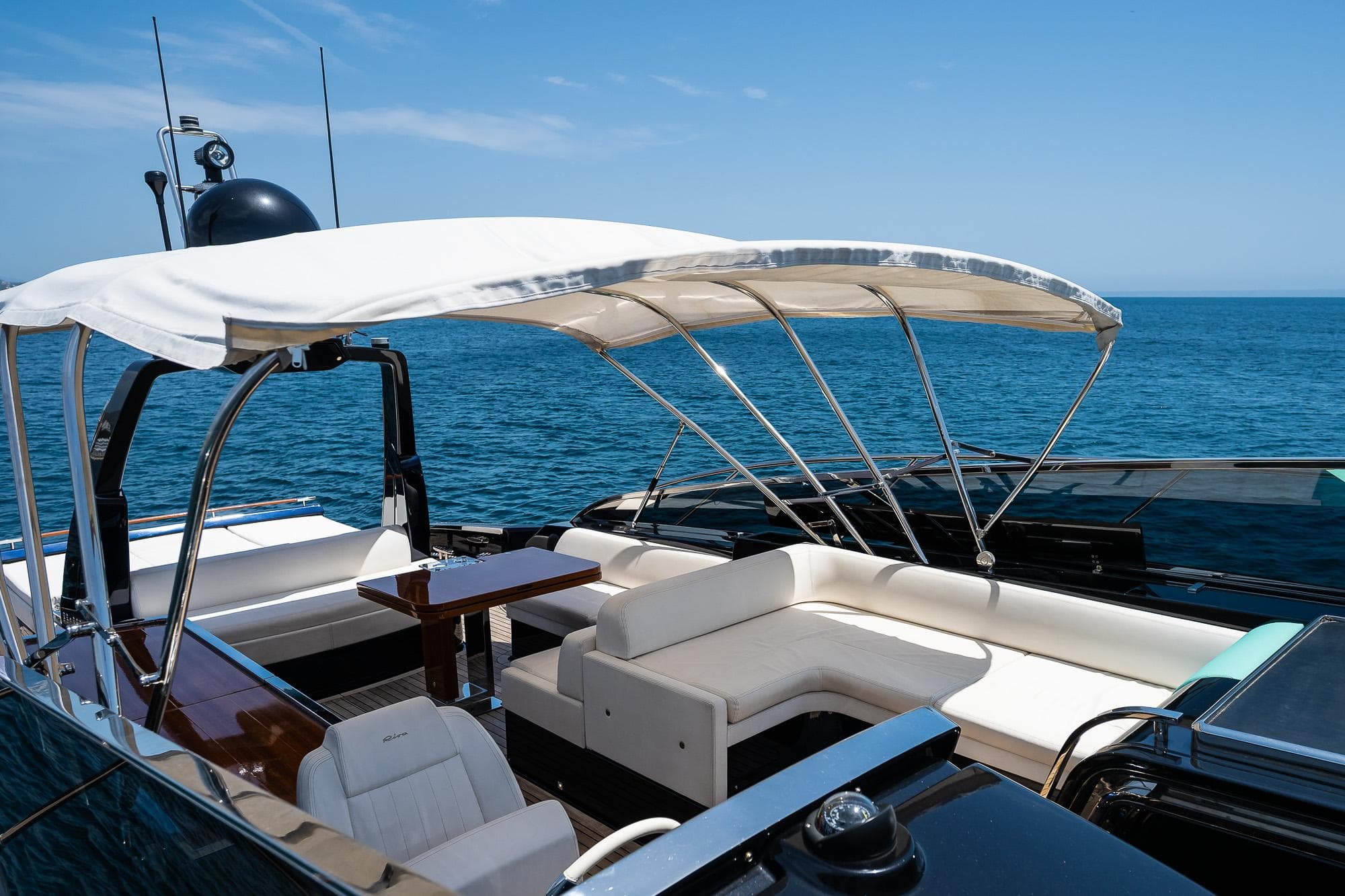 Luxurious 2018 Riva 56' Rivale yacht with elegant seating and canopy on open sea.