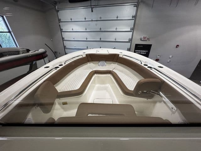 2025 Pioneer Pelagic 270 boat interior with beige seating in a showroom.