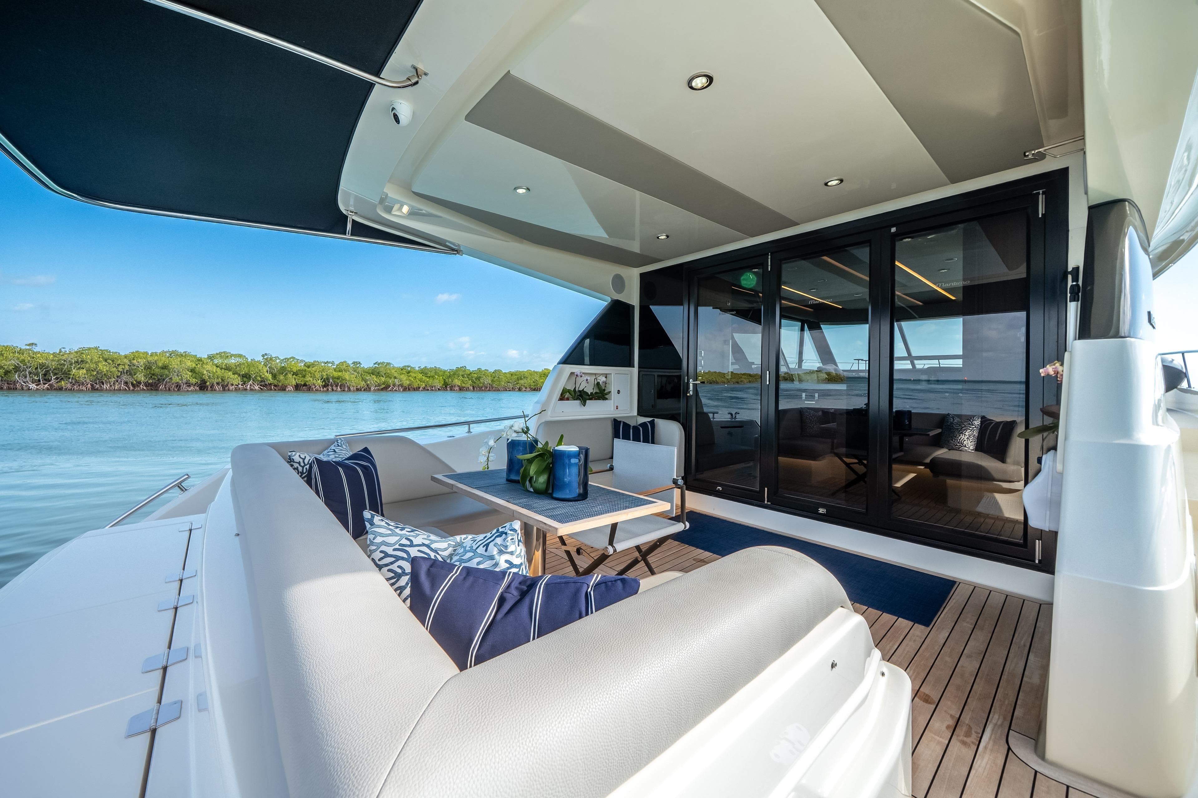 2024 Maritimo M55 yacht deck with luxurious seating and scenic water view.