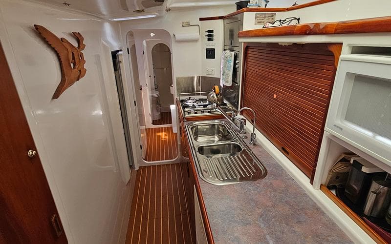 1998 Custom Given1500 yacht kitchen with wooden accents and modern amenities.