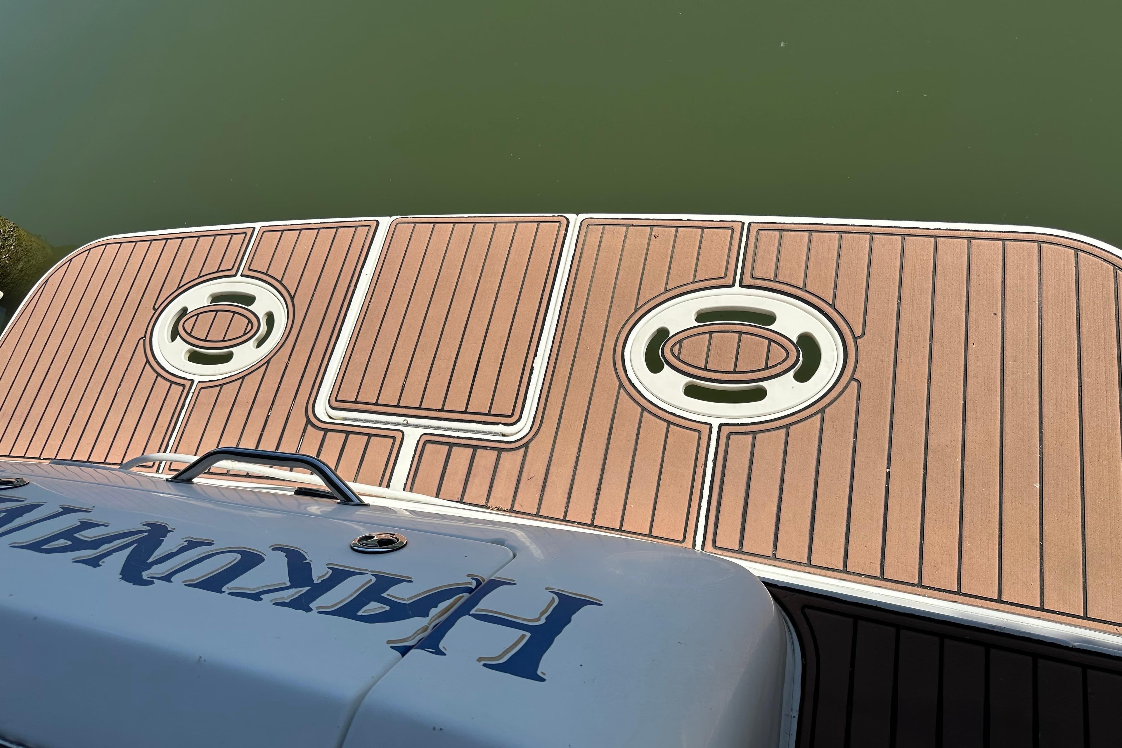 Swim platform of 2000 Sea Ray Sundancer 310, featuring teak-style decking.