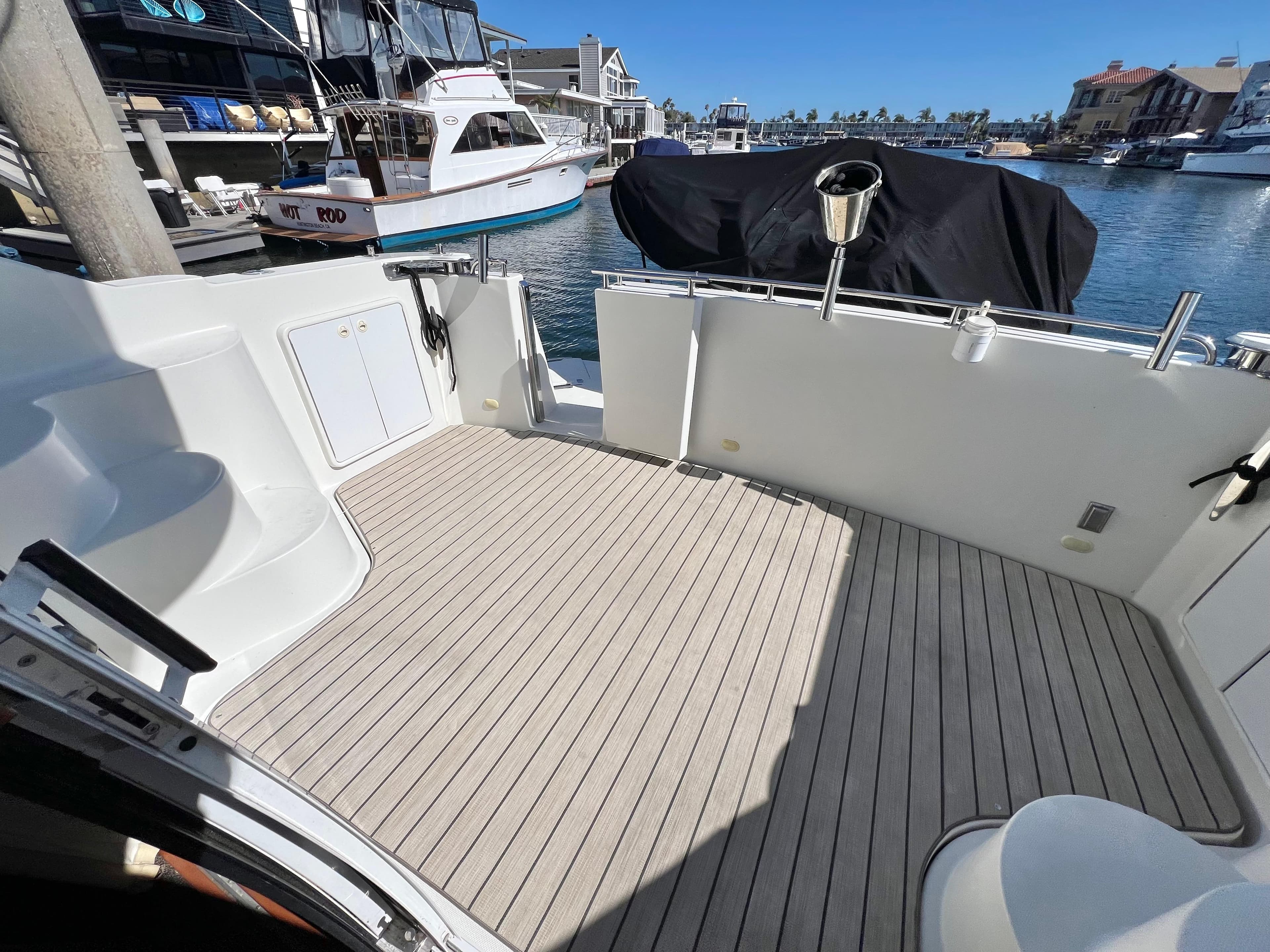 2004 Carver 420 Mariner boat deck with wood flooring, docked in a marina.