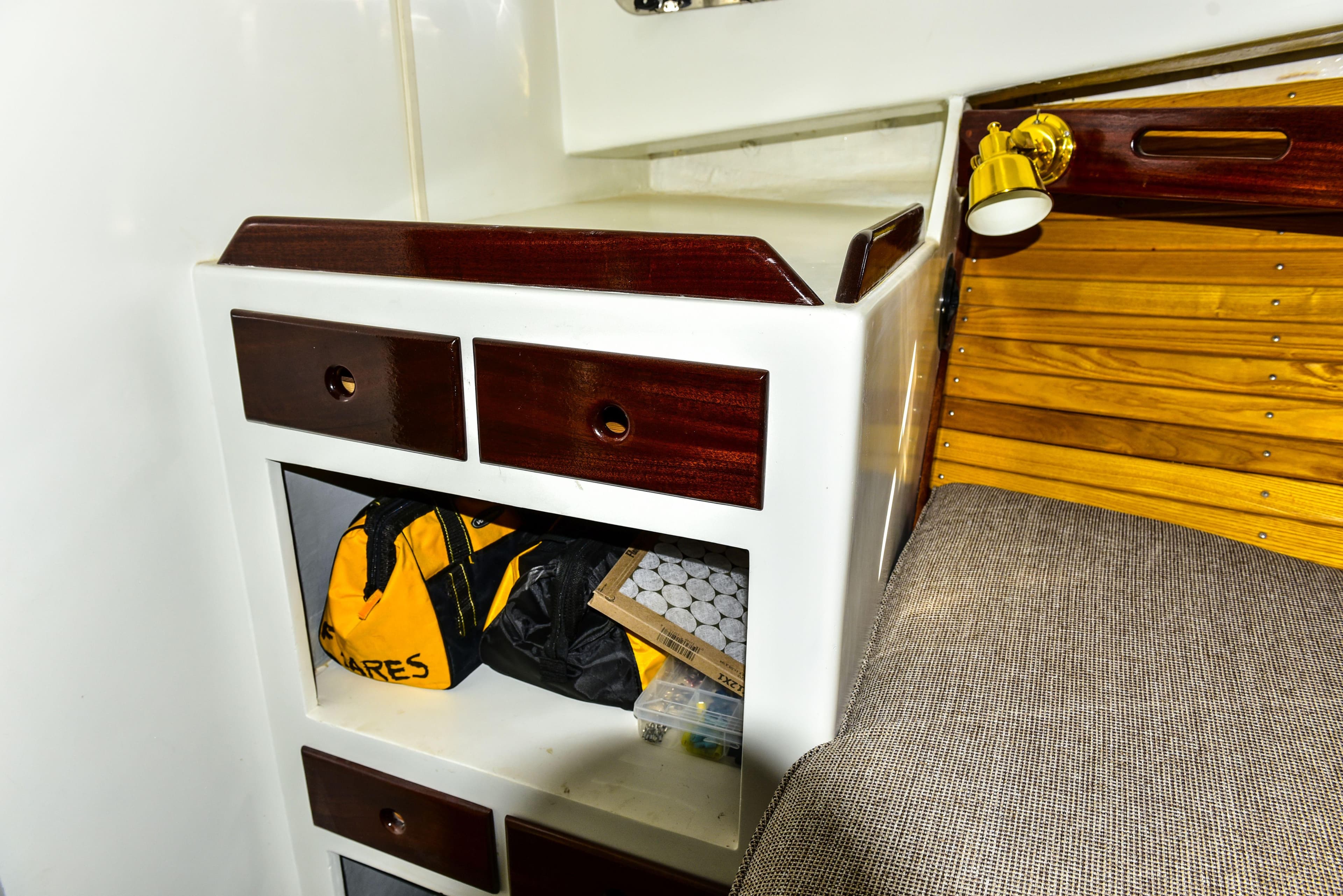Interior of 1998 Duffy 35 Downeast Cruiser with storage drawers and cozy seating.